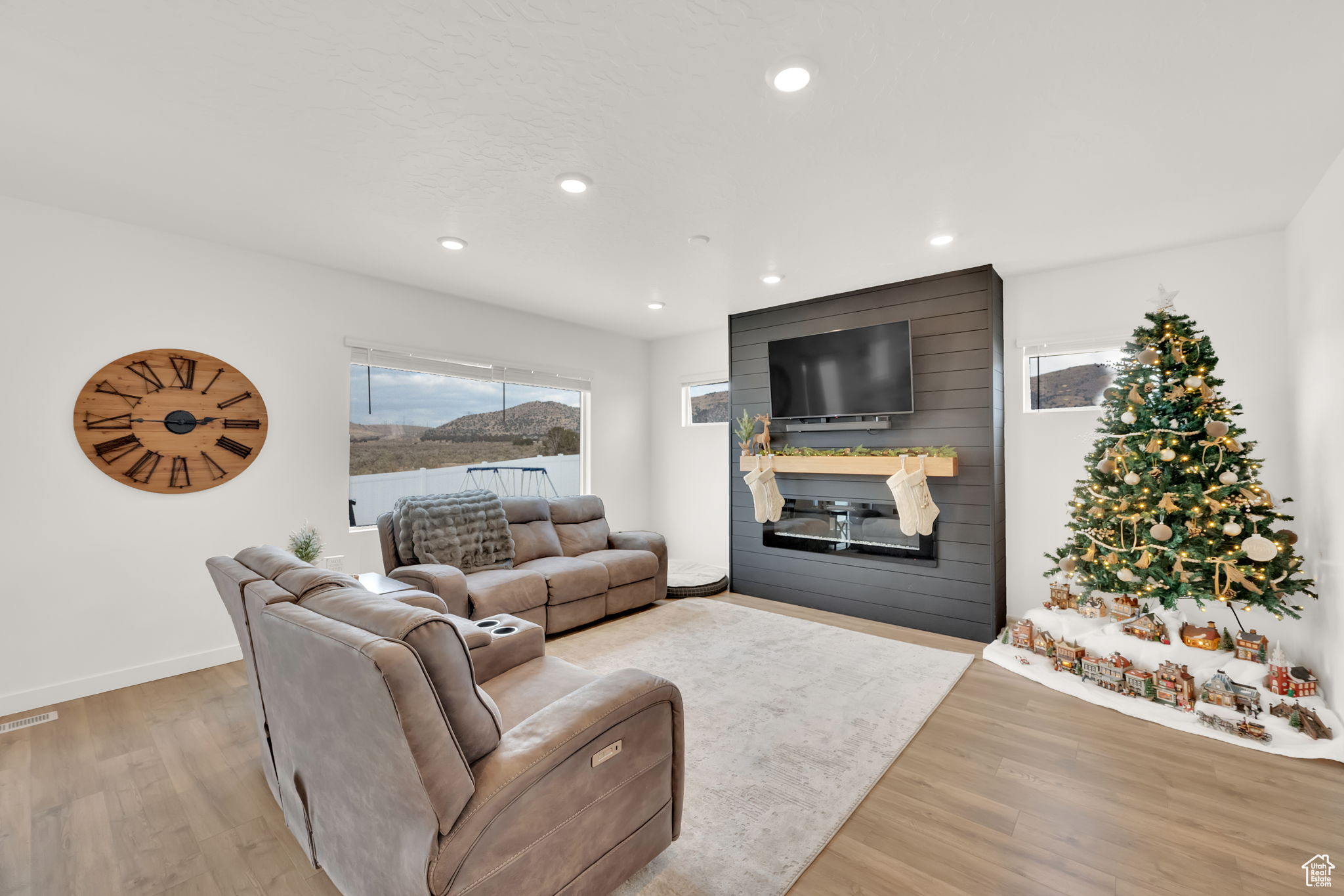 Living room with light hardwood / wood-style floors and a fireplace