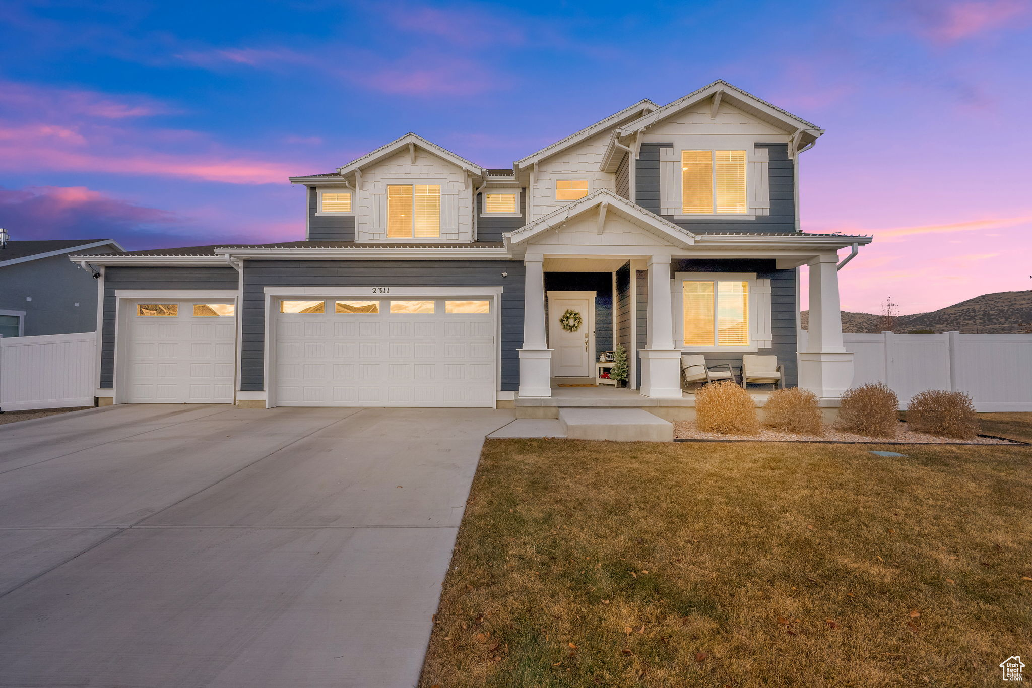 Craftsman inspired home featuring a lawn and a garage