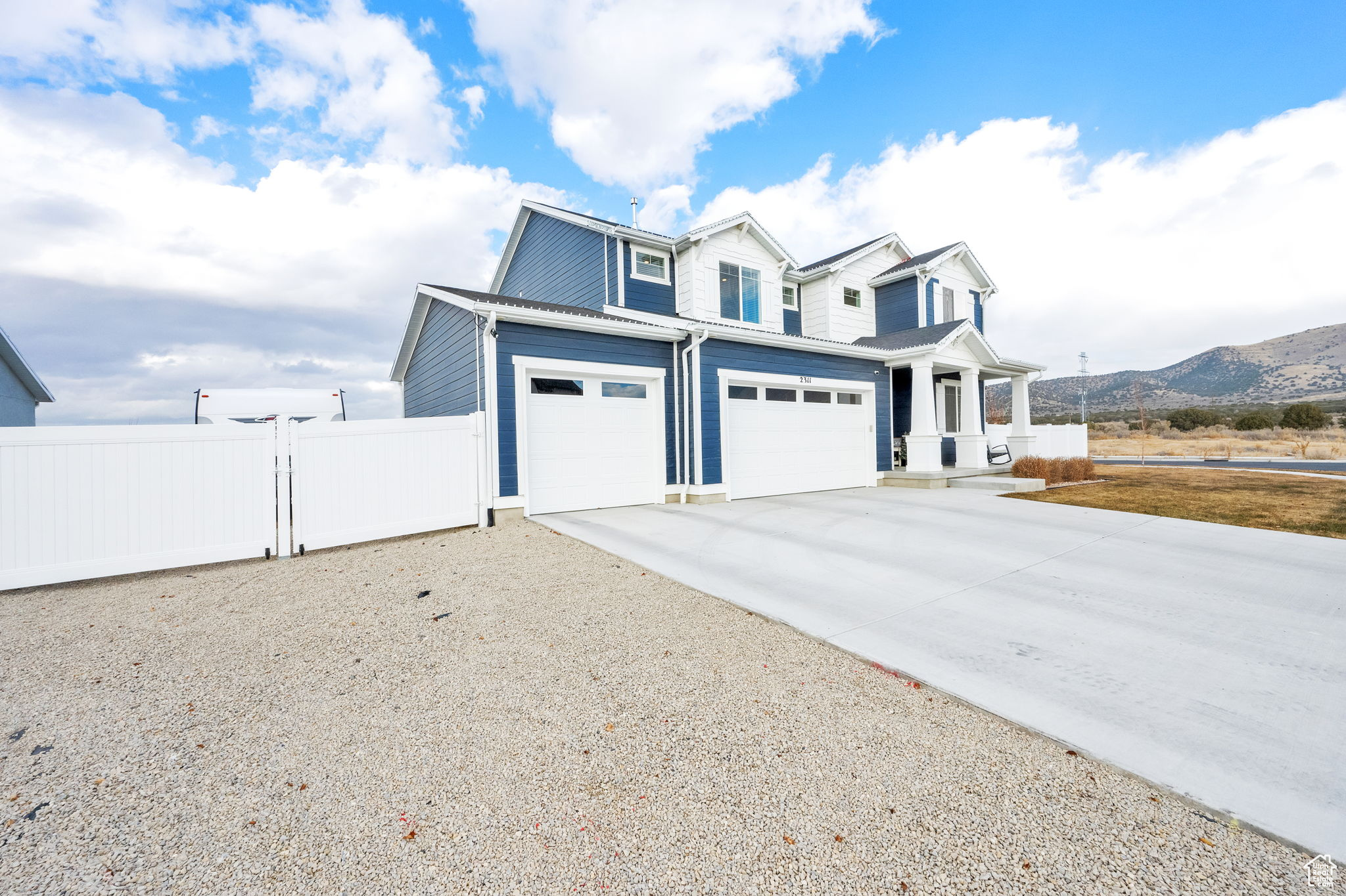 View of front facade with a mountain view and a garage