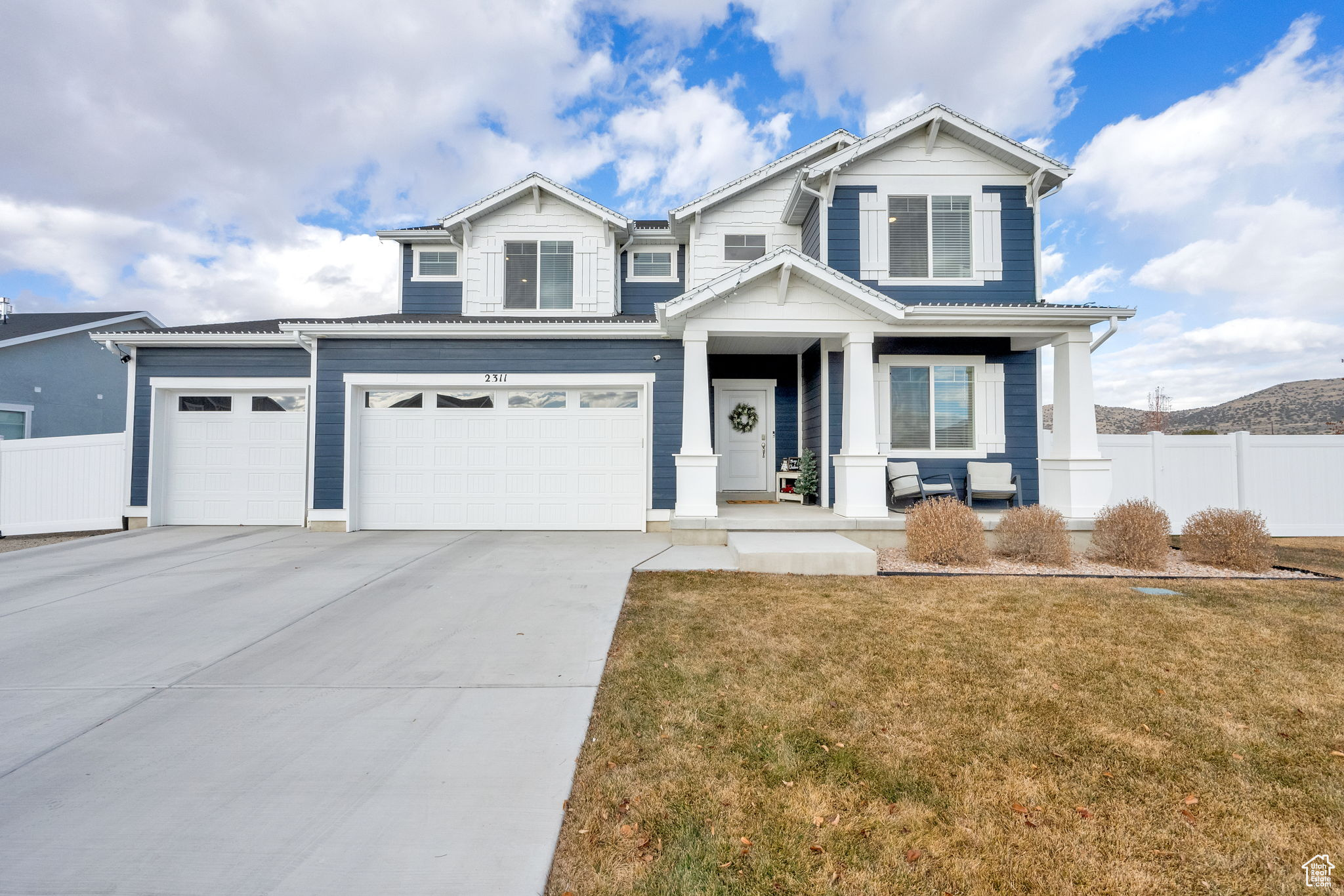 Craftsman house featuring a garage and a front yard