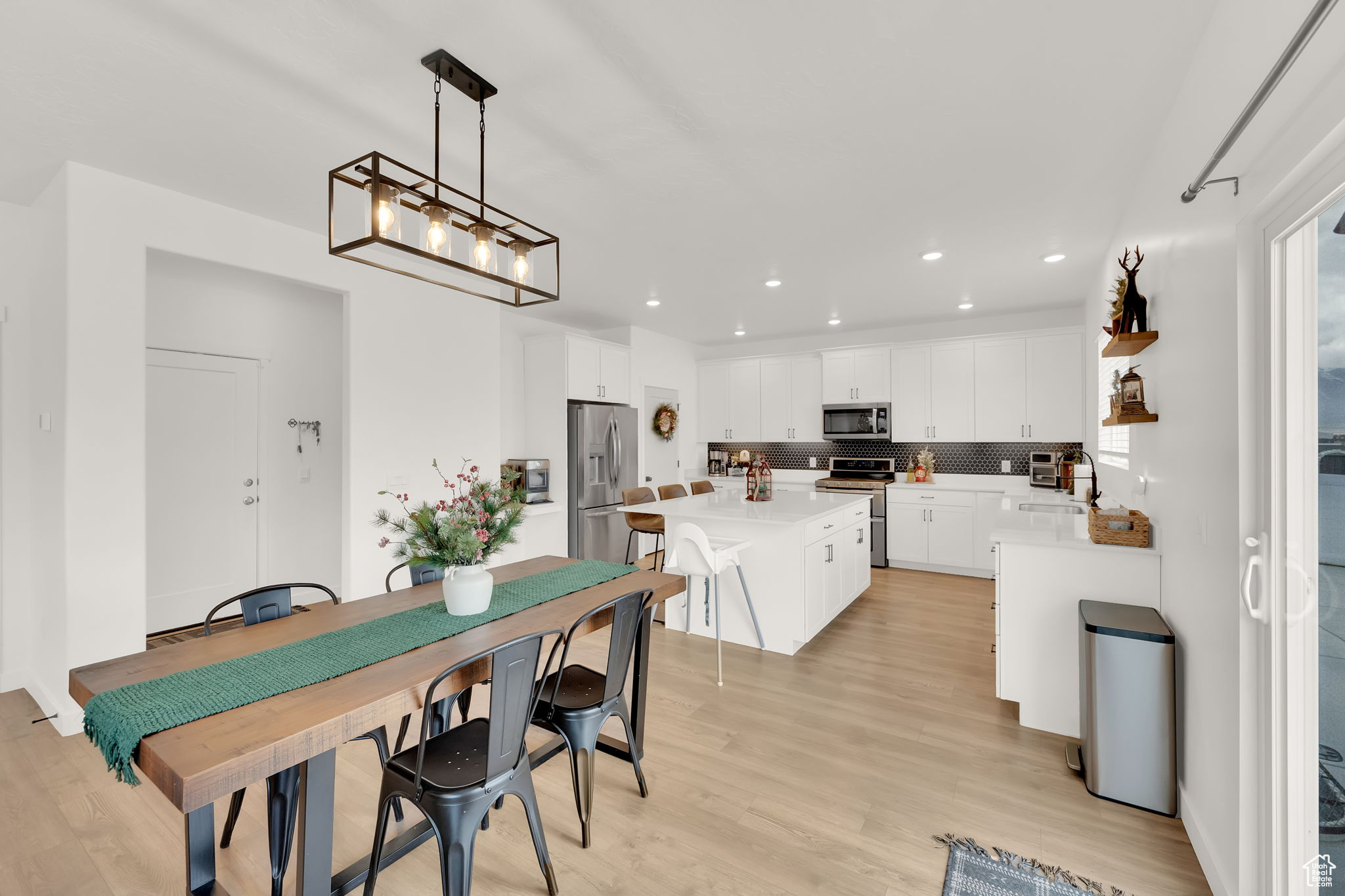 Dining area featuring light hardwood / wood-style floors, a notable chandelier, and sink