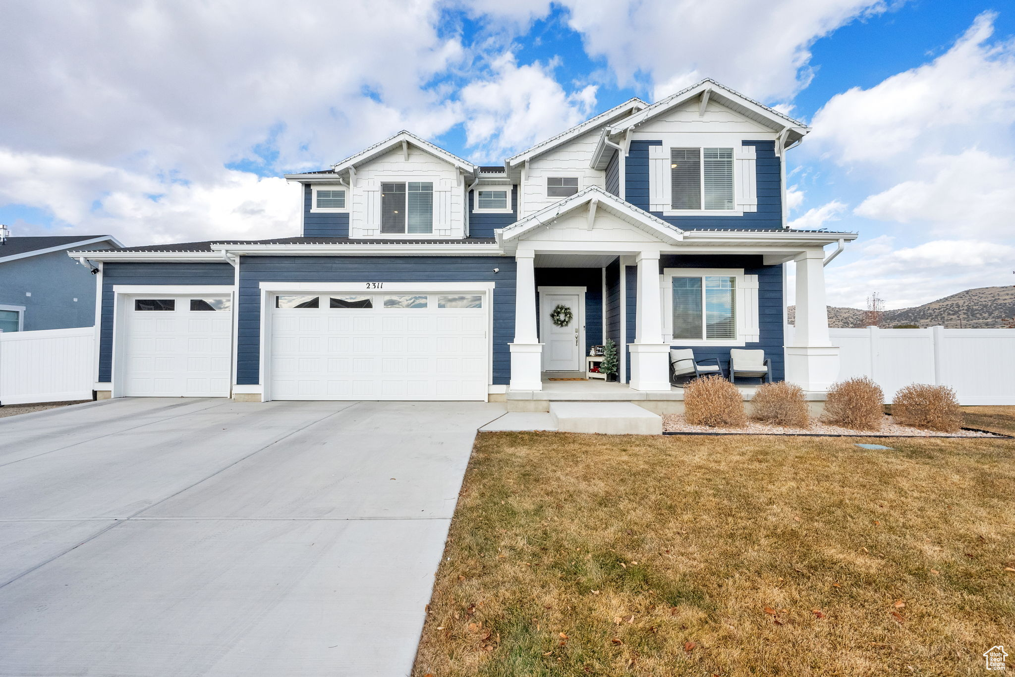 Craftsman-style home featuring a front yard and a garage