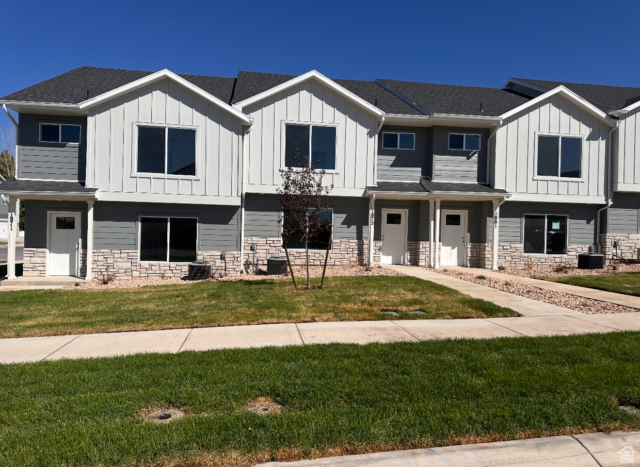 View of front of house with a front lawn and central air condition unit