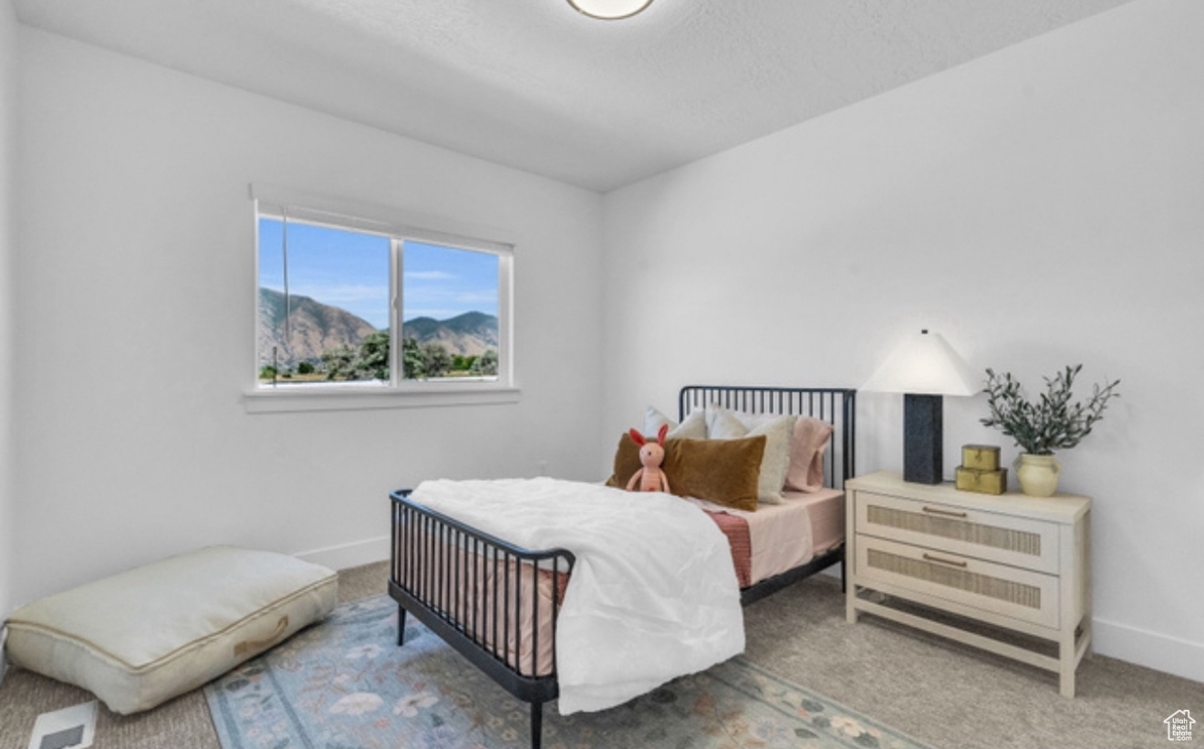 Bedroom featuring carpet flooring and a mountain view