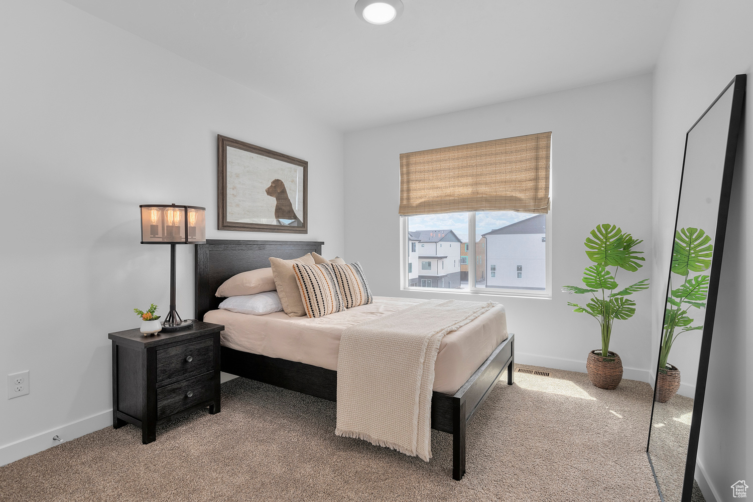 Bedroom featuring light carpet