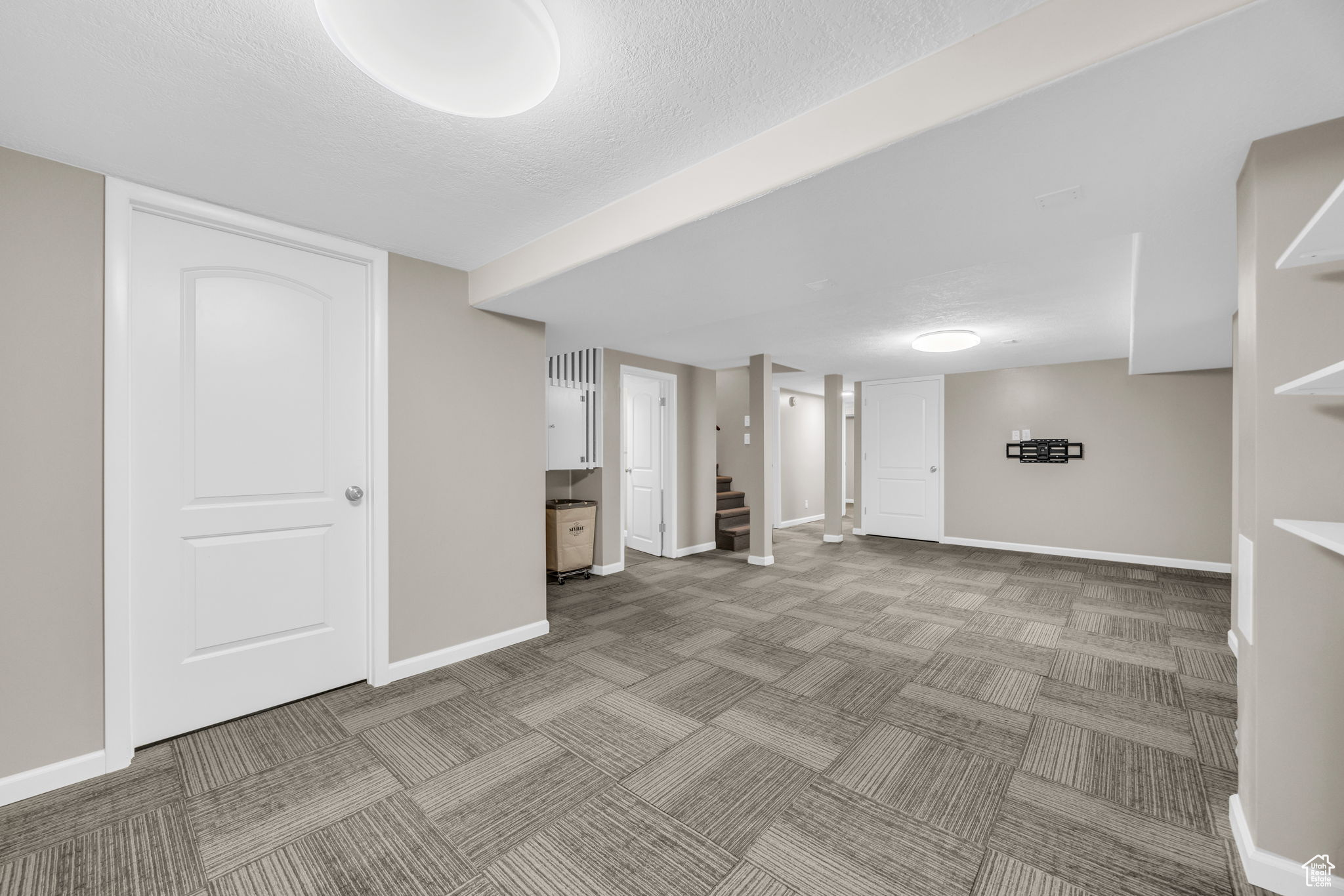 Basement featuring a textured ceiling