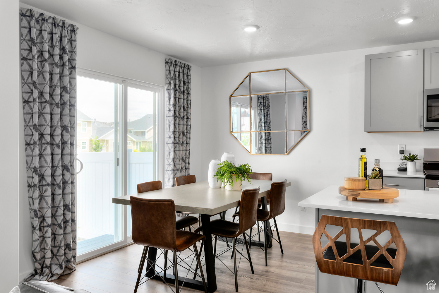 Dining space with light hardwood / wood-style flooring