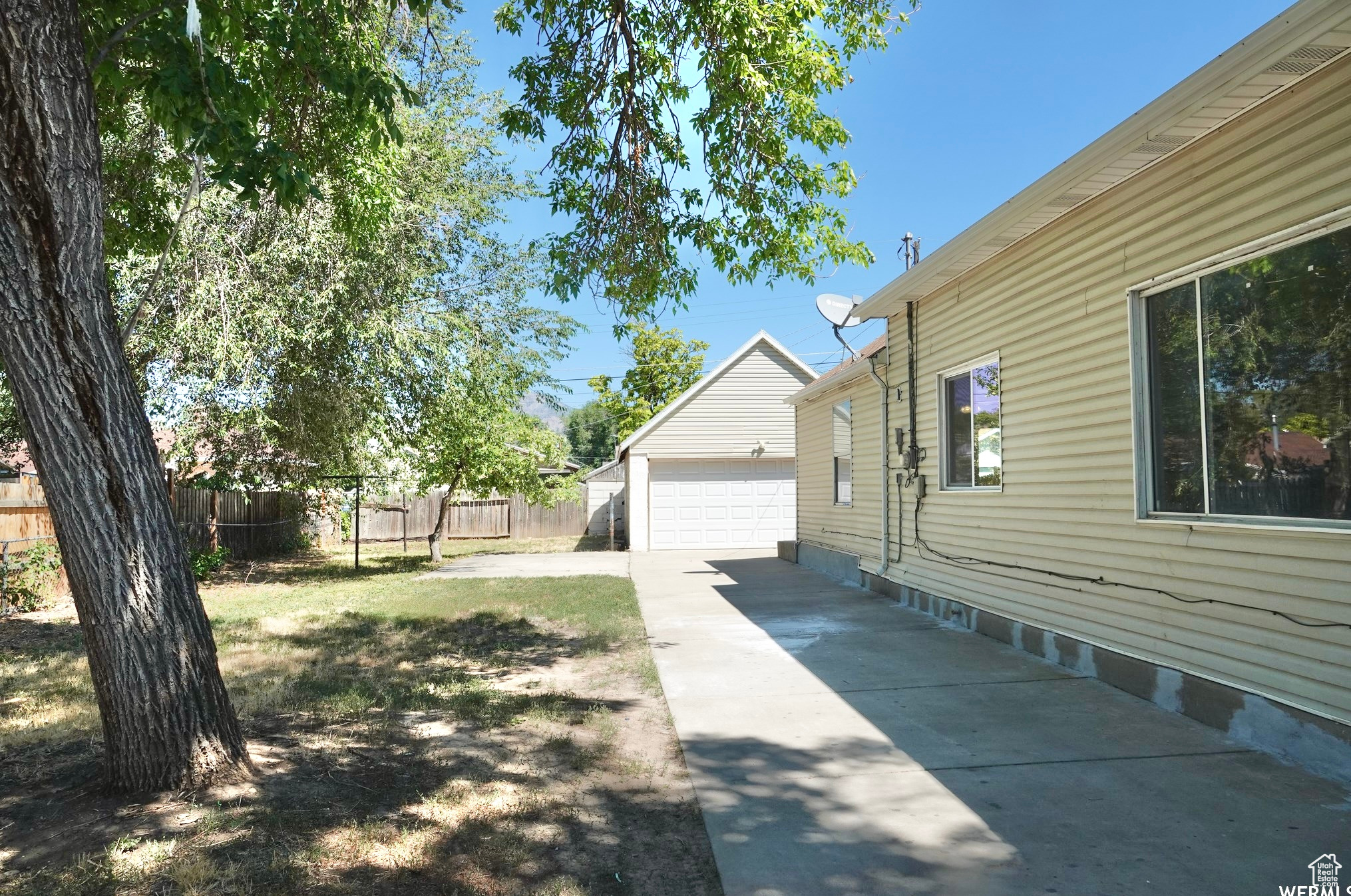 View of yard featuring a garage and an outdoor structure