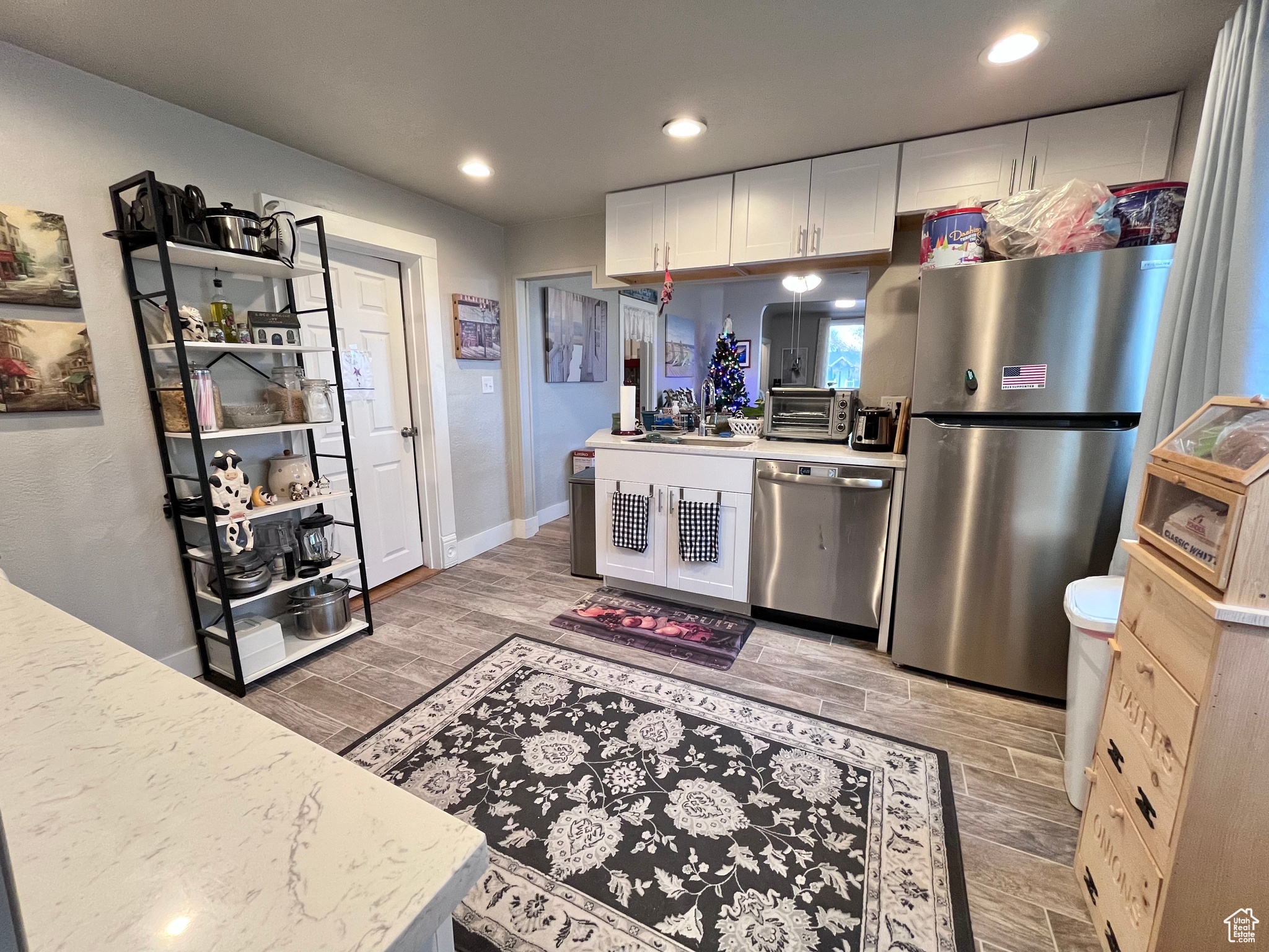 Kitchen with white cabinets, stainless steel appliances, and sink