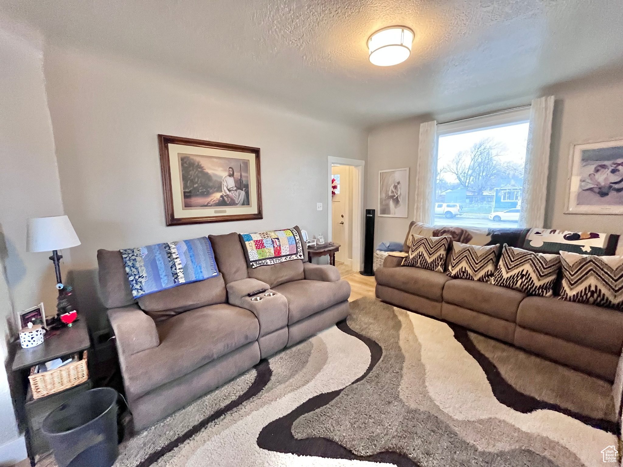 Living room with hardwood / wood-style floors and a textured ceiling