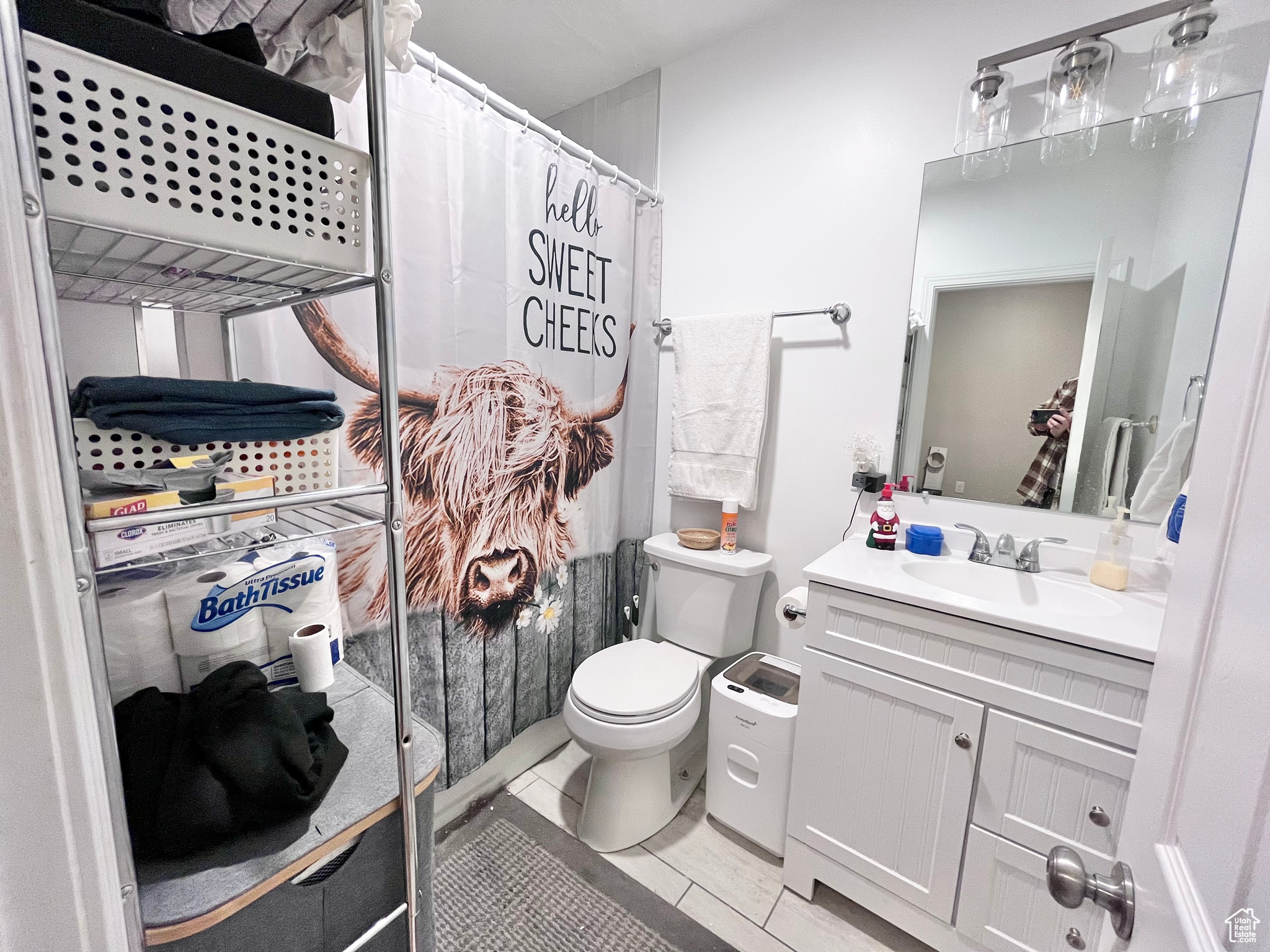 Bathroom with tile patterned flooring, vanity, toilet, and a shower with curtain