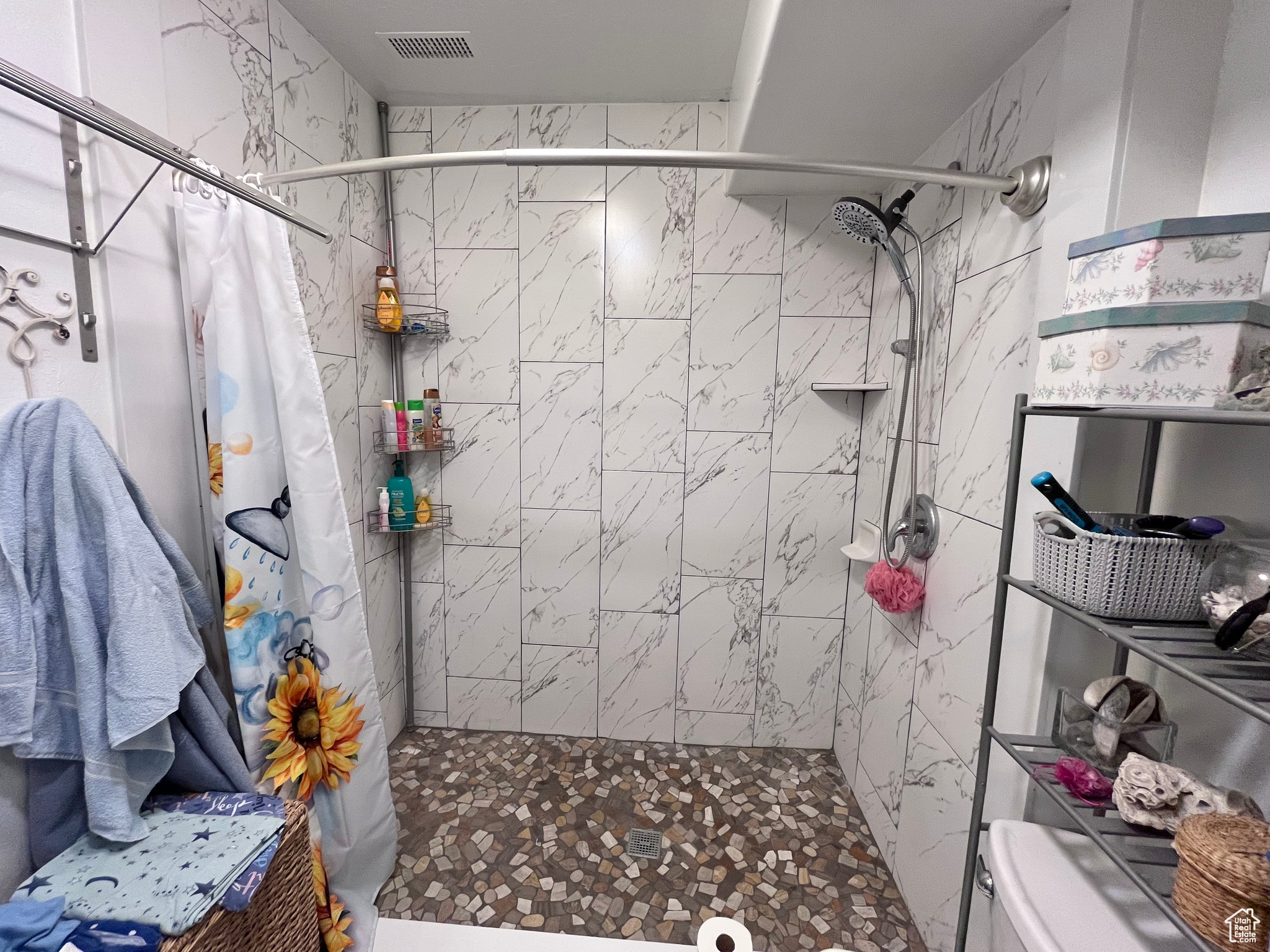 Bathroom featuring a shower with curtain