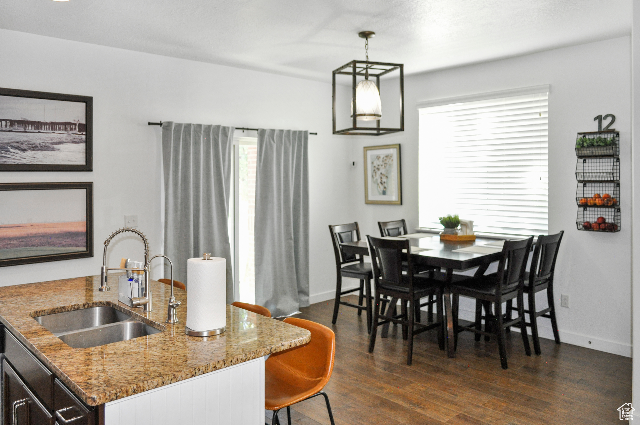 Dining space with sink and dark hardwood / wood-style floors