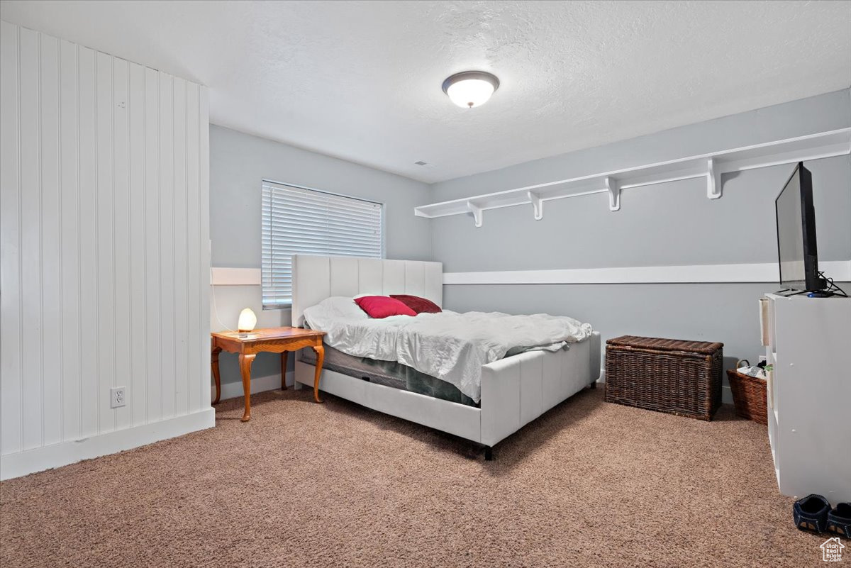 Bedroom with carpet floors and a textured ceiling