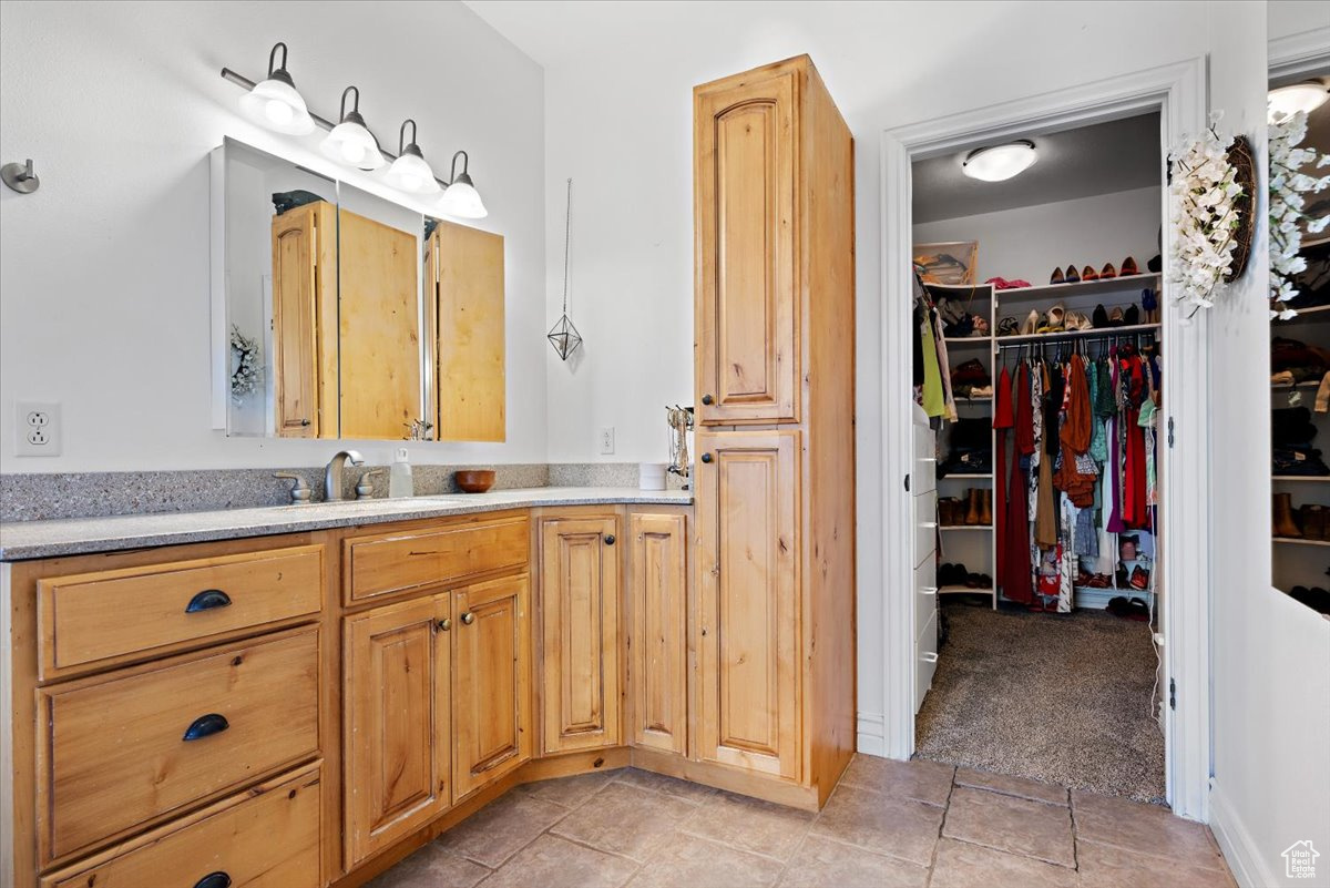 Bathroom featuring tile patterned flooring and vanity