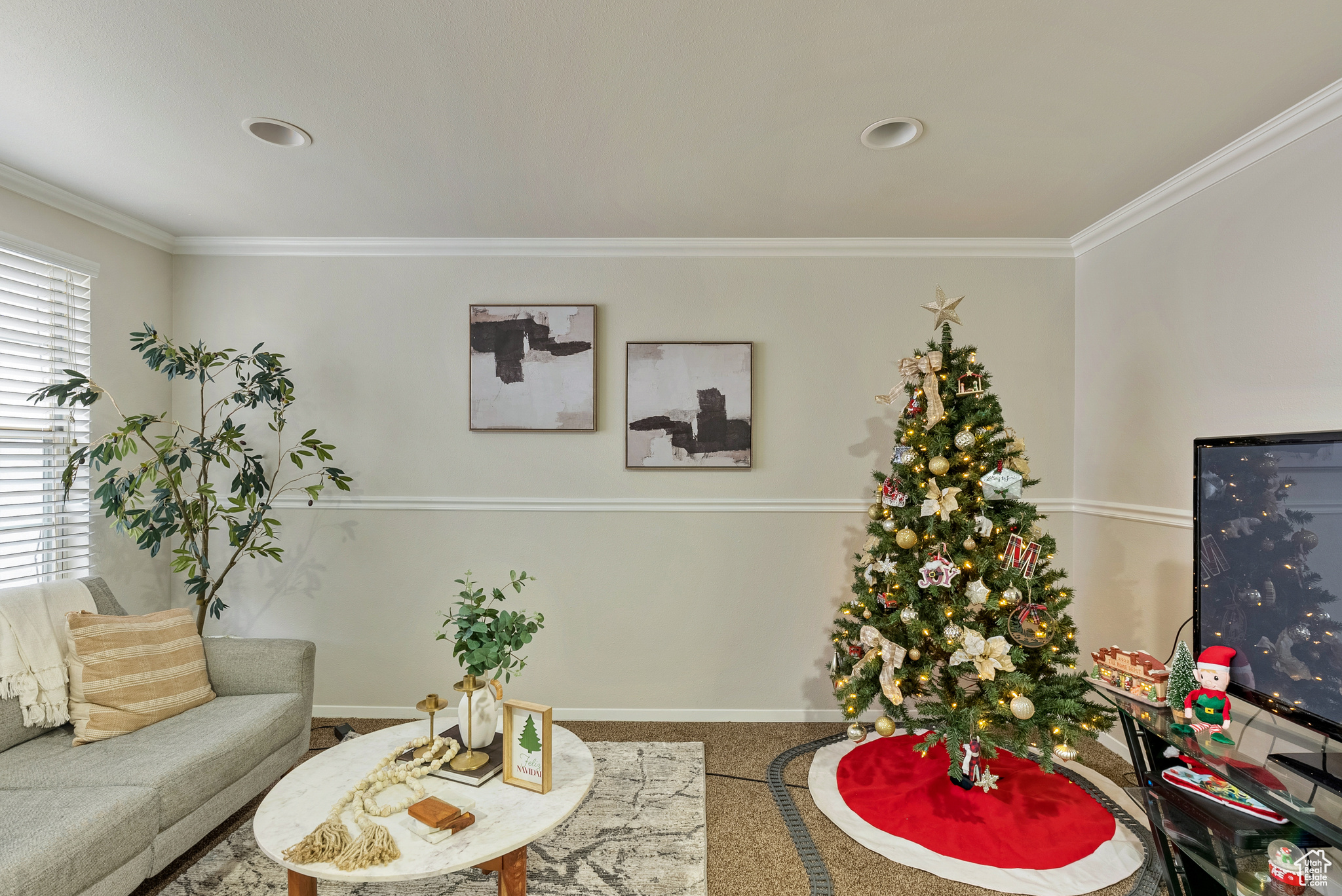 Carpeted living room featuring crown molding