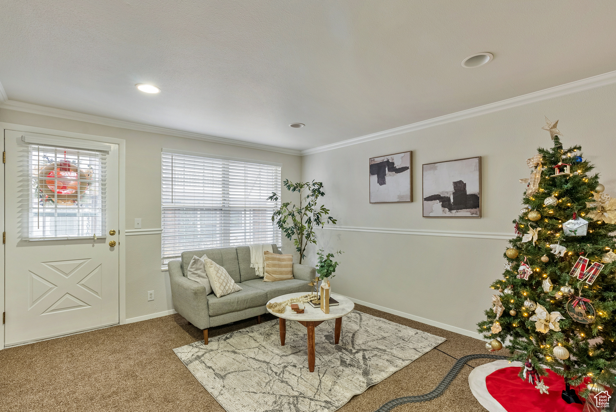 Living room featuring carpet and ornamental molding