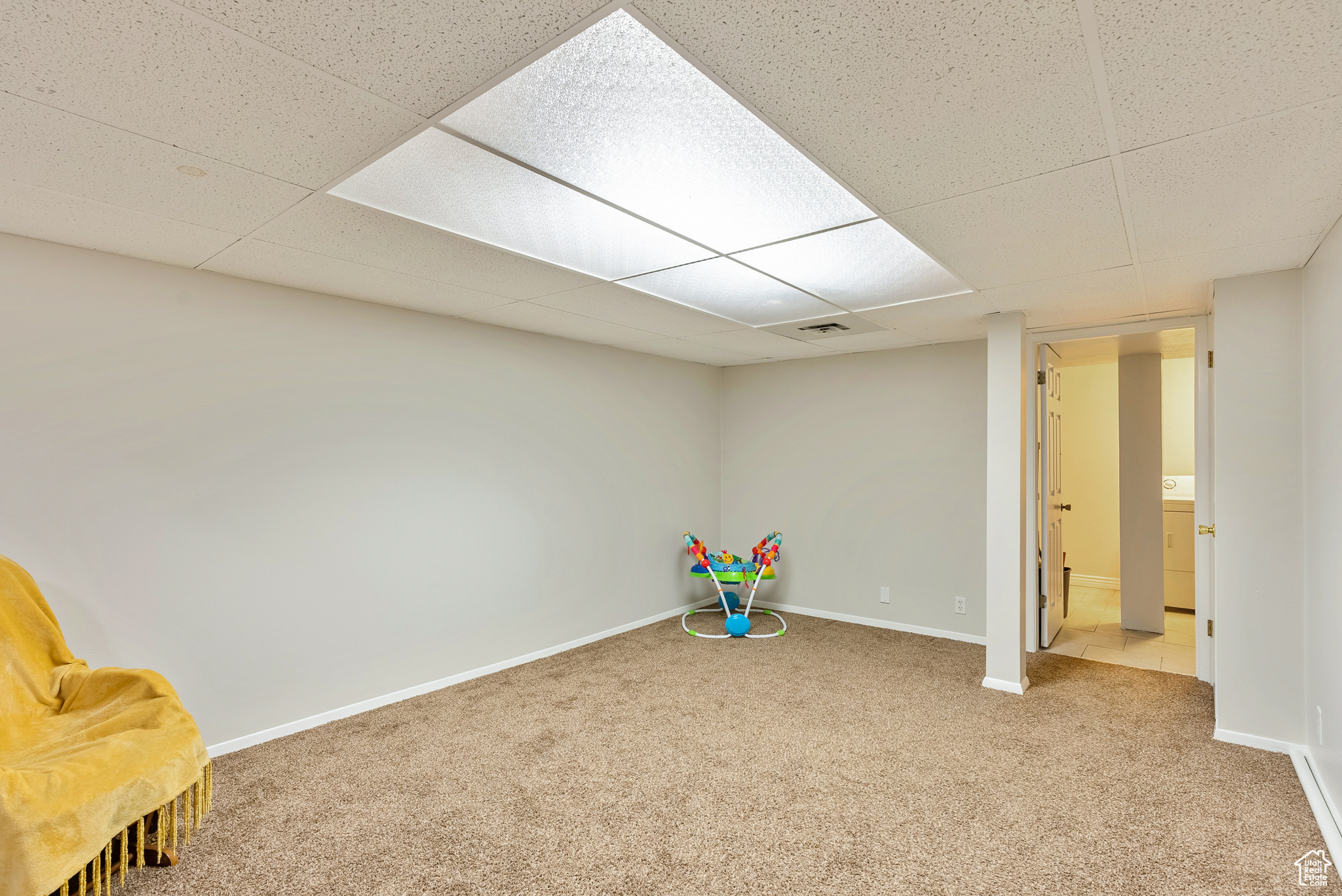 Game room with a paneled ceiling, washer / dryer, and carpet