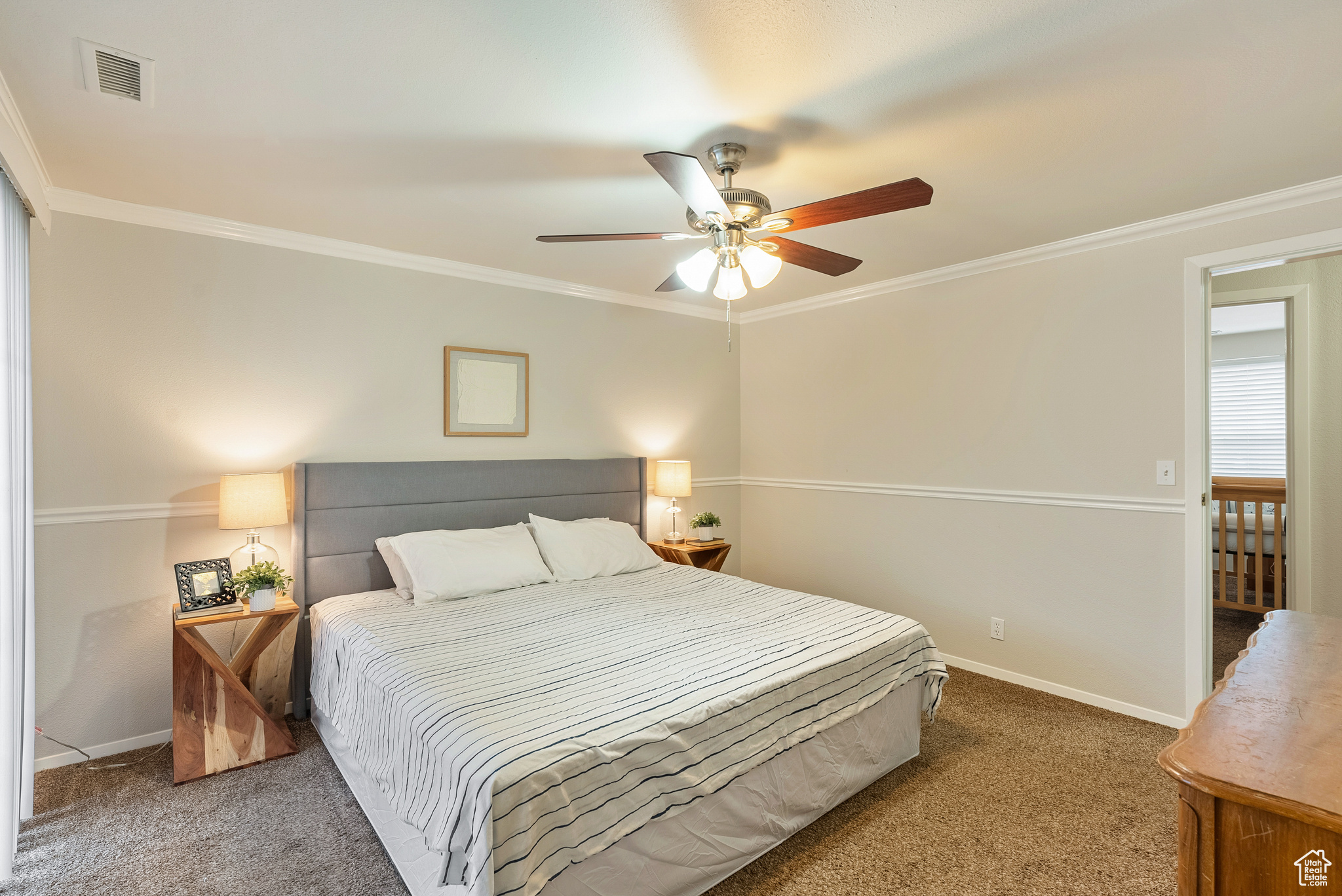 Bedroom with carpet, ceiling fan, and ornamental molding