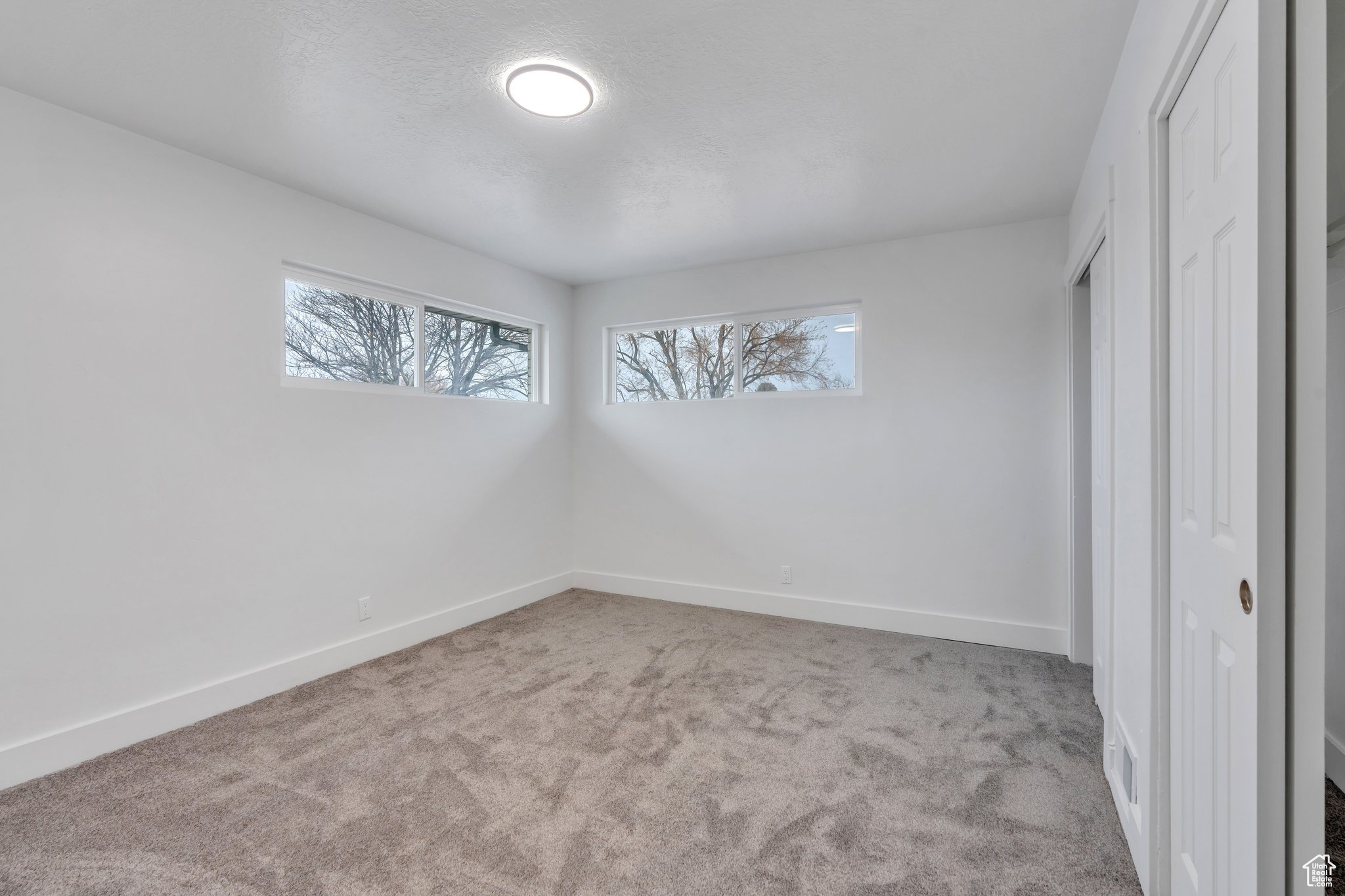 Unfurnished bedroom featuring light colored carpet