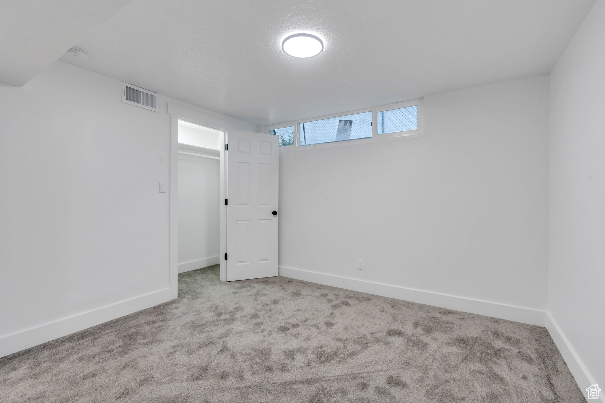 Basement with light colored carpet