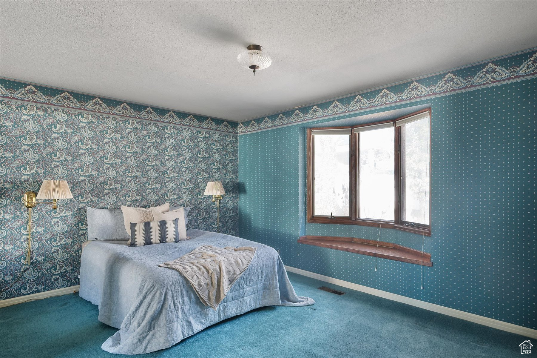 Primary bedroom with a bay window & window seat