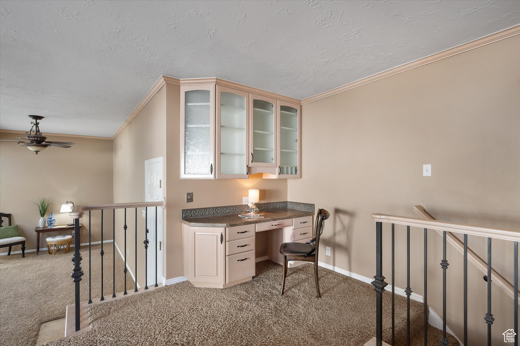 Built-in desk with glass fronted cabinets