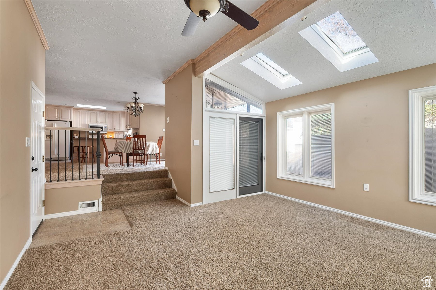 View from sunroom back to kitchen & semi-formal dining