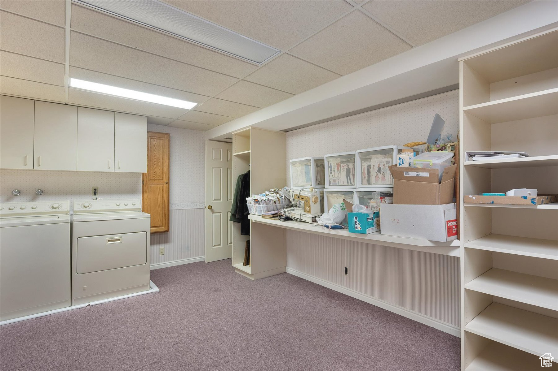 Craft/Laundry with tons of shelving and a big counter for working on projects