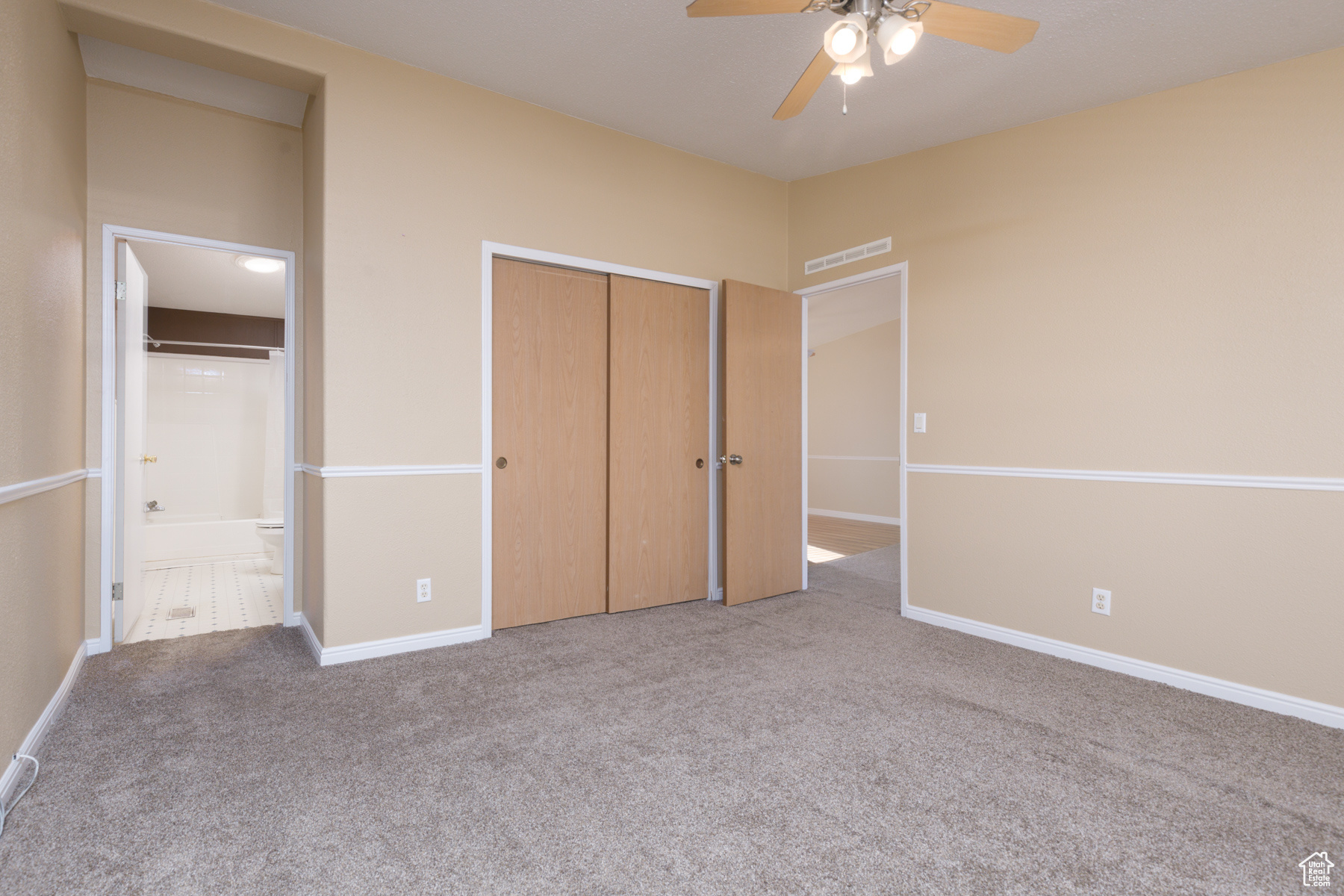 Unfurnished bedroom with a closet, light colored carpet, and ceiling fan