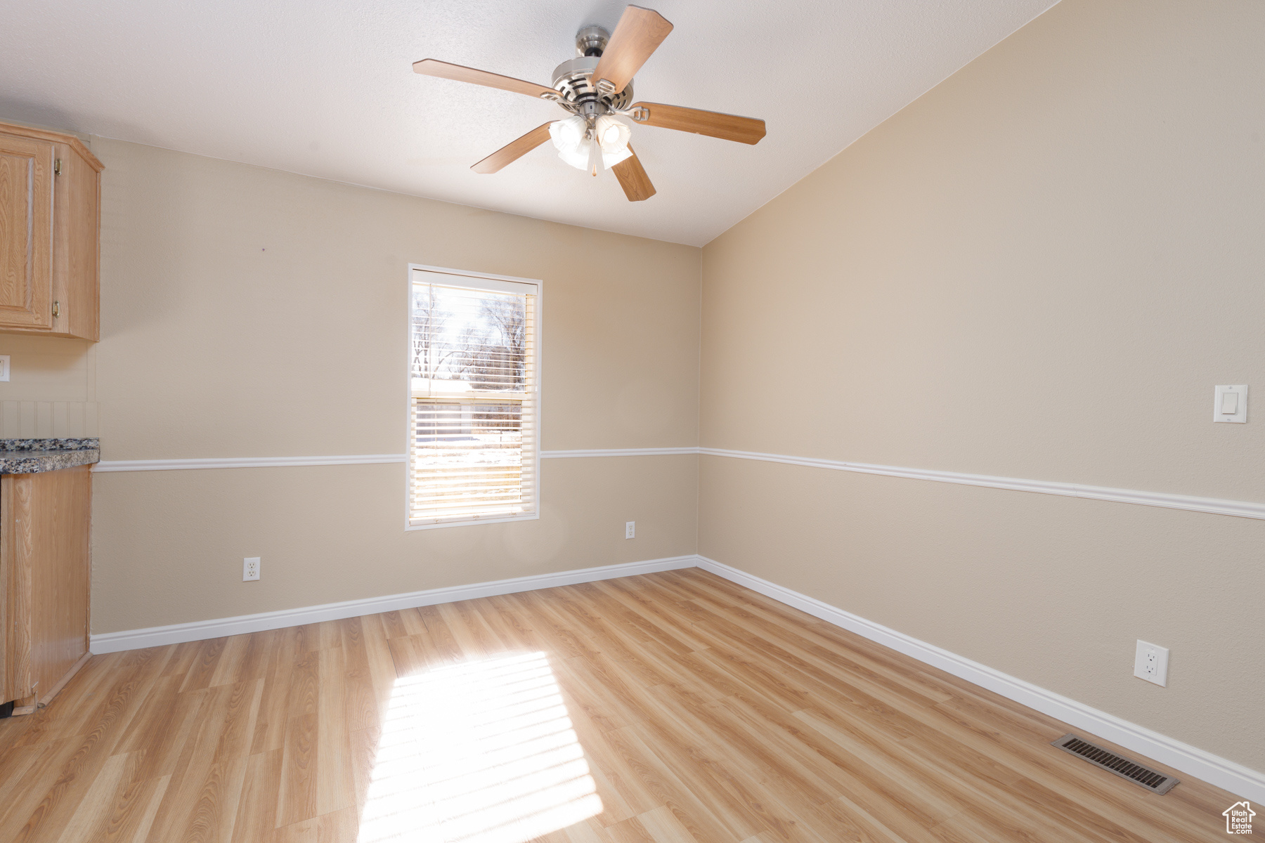 Spare room featuring light hardwood / wood-style floors and ceiling fan