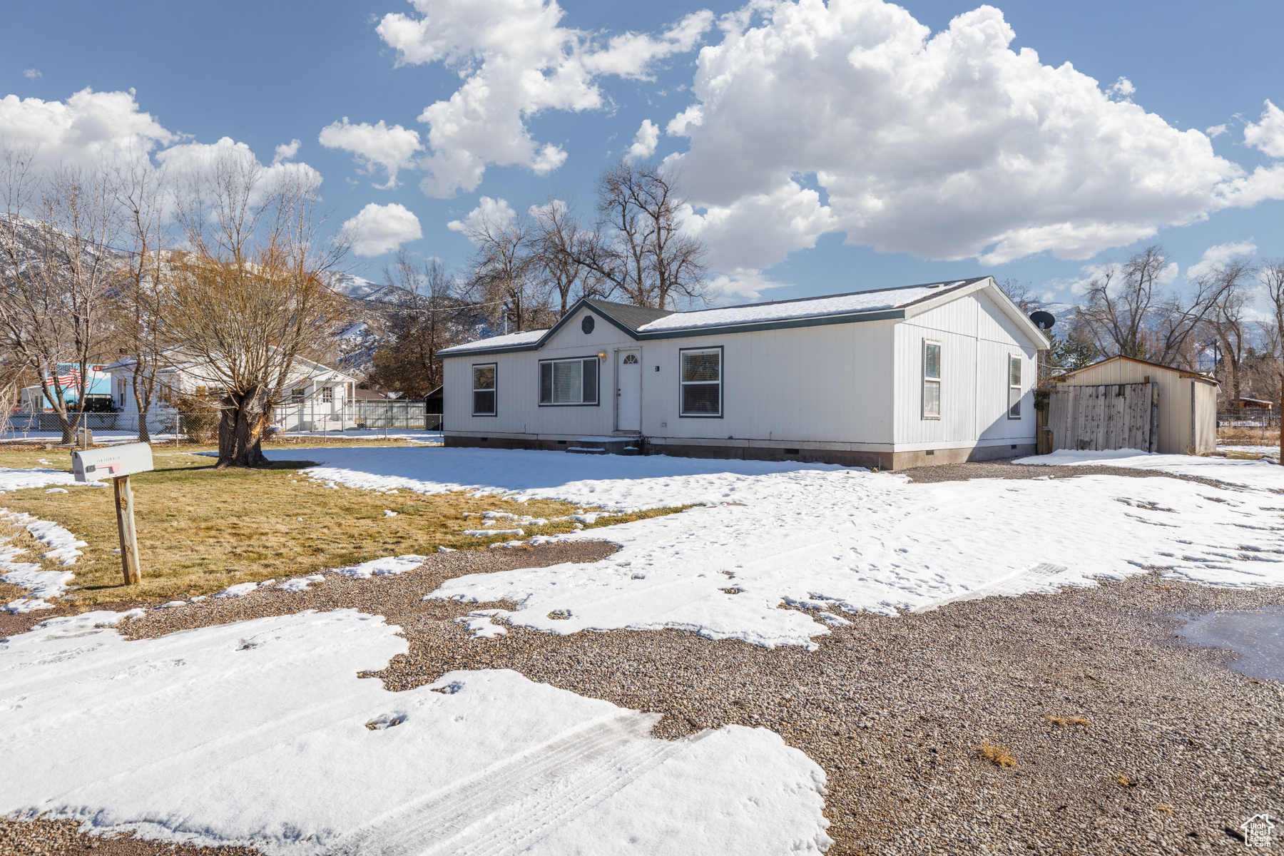 View of front of house featuring a mountain view and a shed