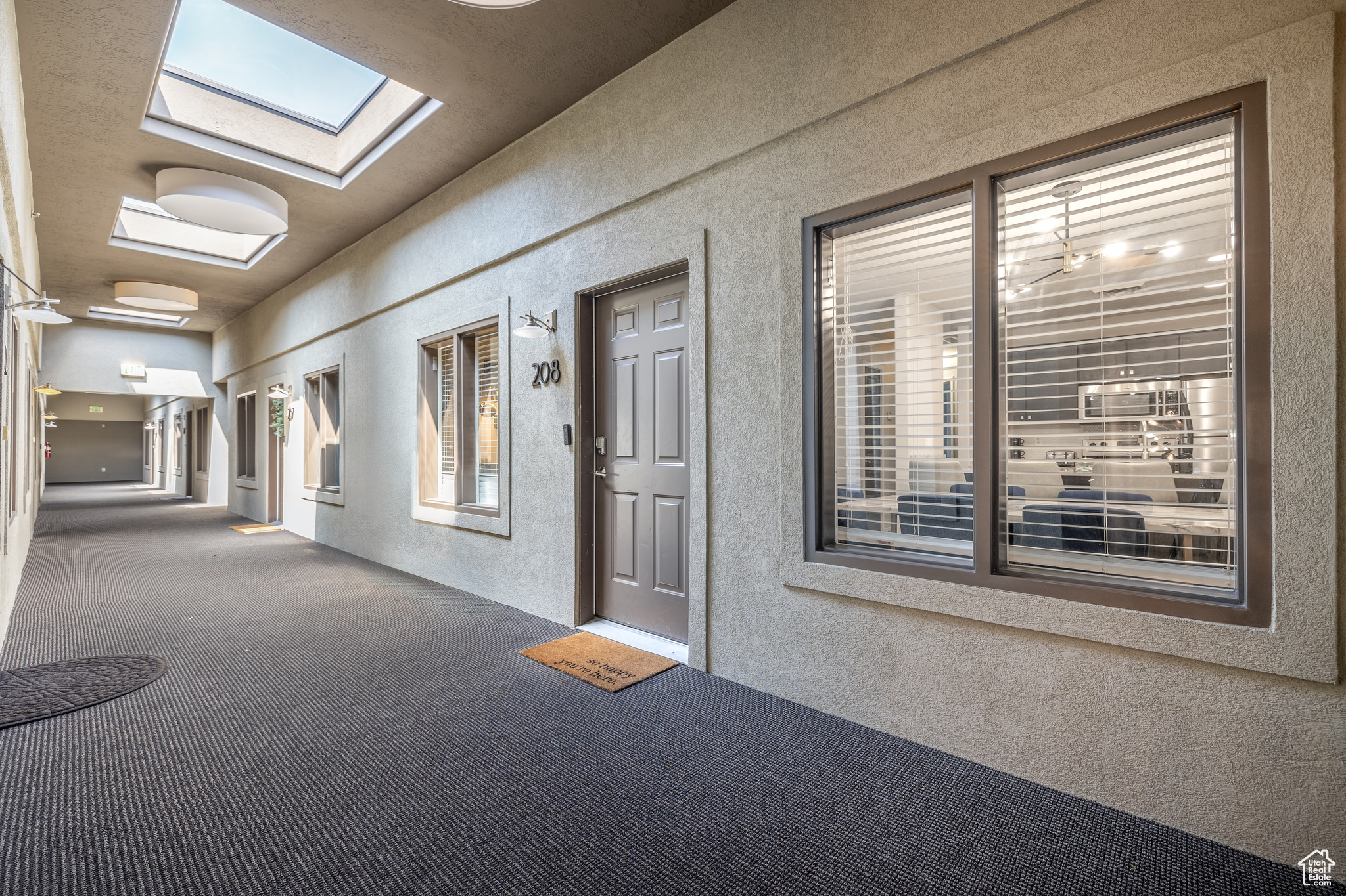 Hallway featuring carpet flooring and a skylight