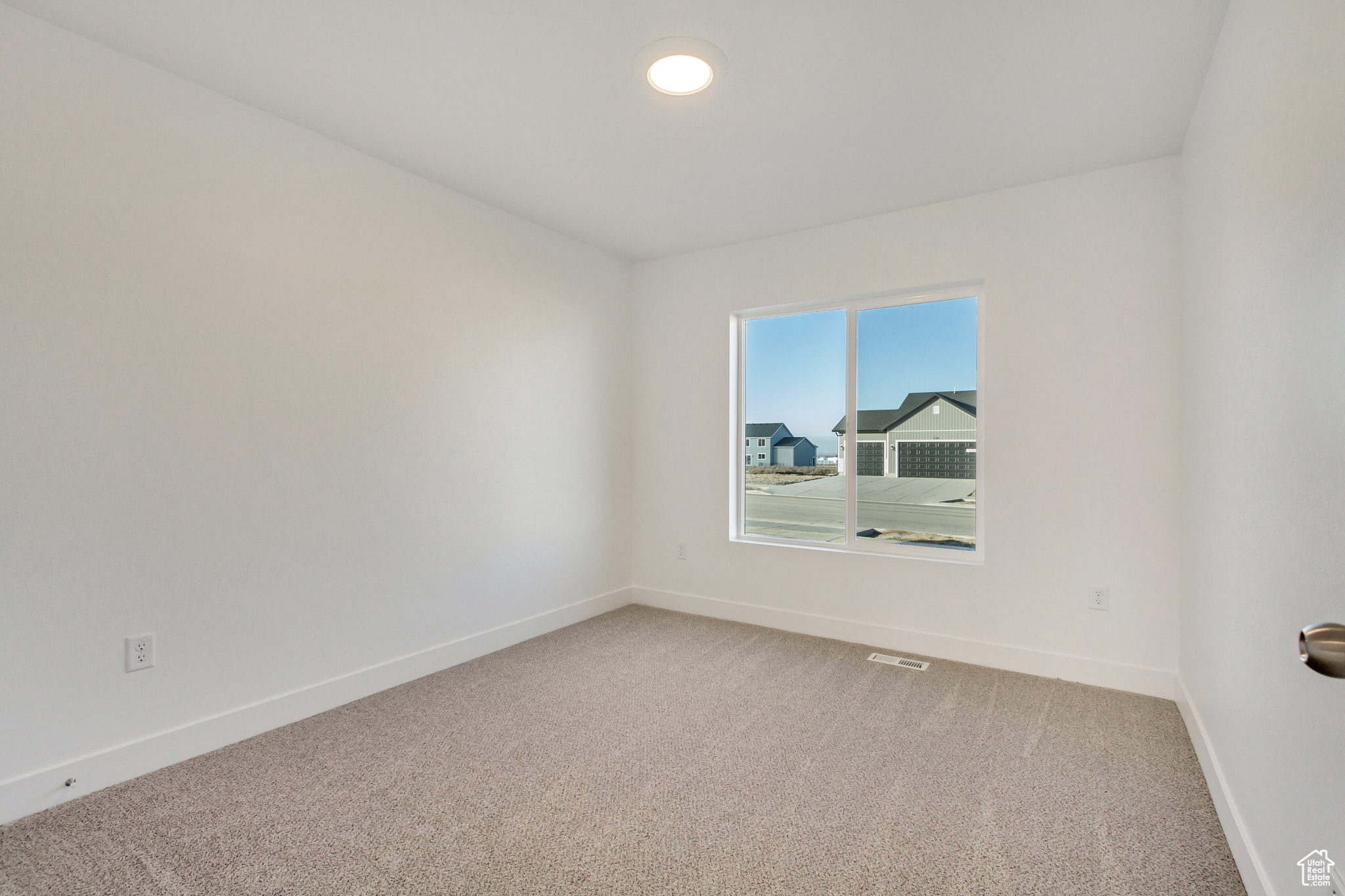 View of carpeted spare room