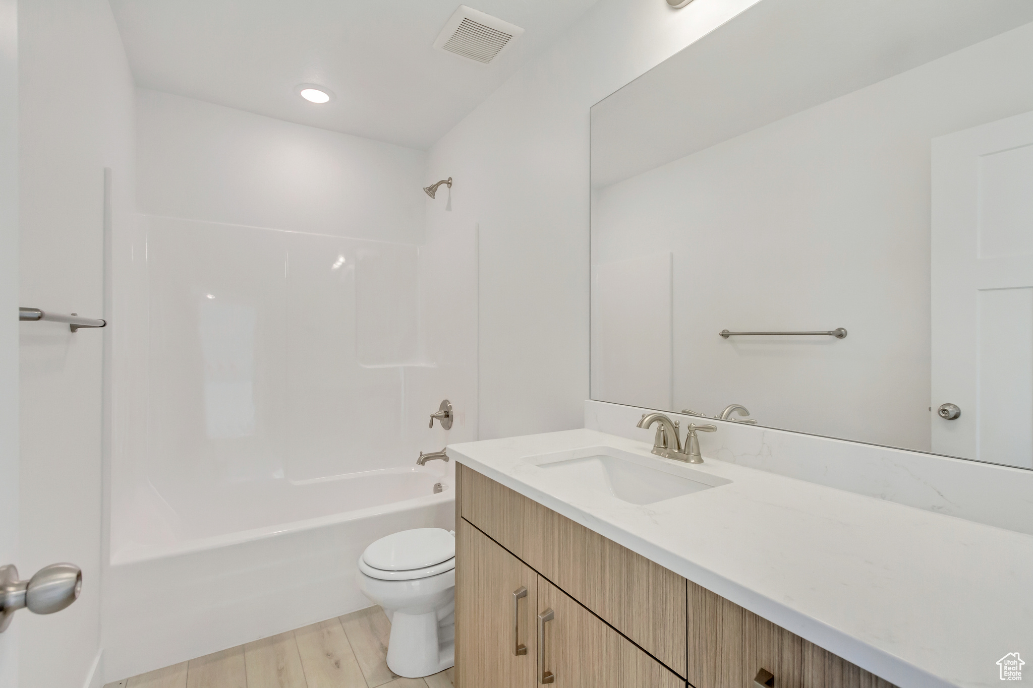 Full bathroom featuring bathing tub / shower combination, vanity, wood-type flooring, and toilet