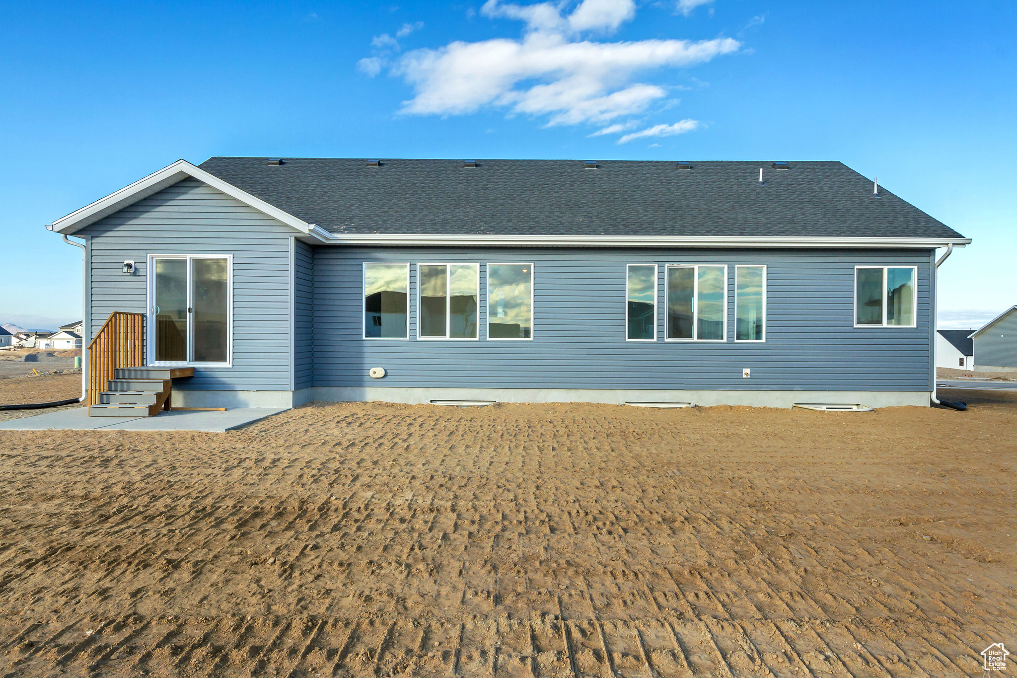 Back of house featuring a lawn and a patio area