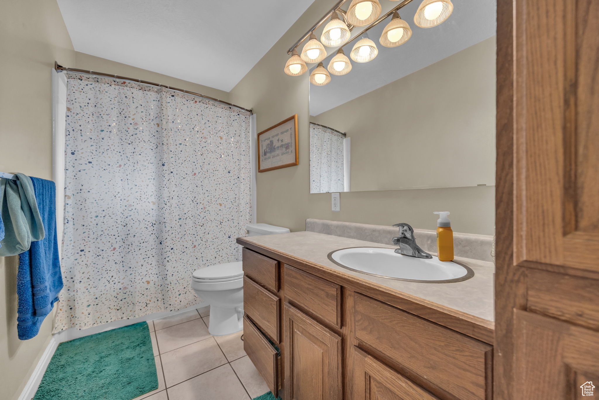 Bathroom with tile patterned flooring, vanity, and toilet