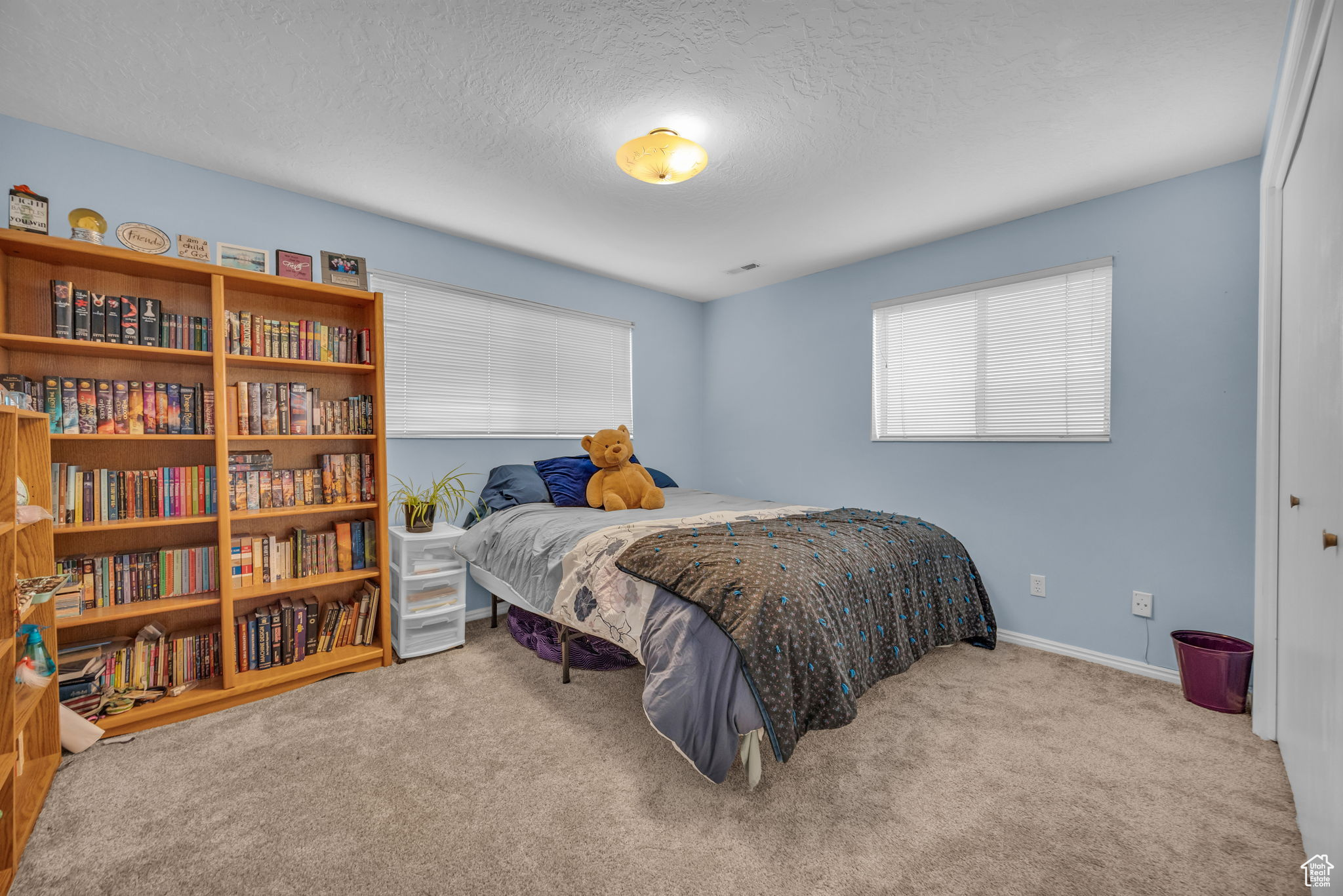 Carpeted bedroom with a textured ceiling