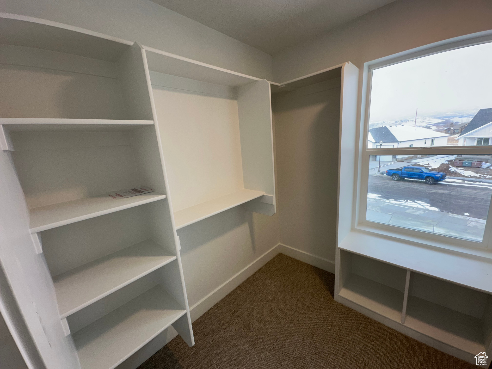 Owner's walk in closet with space saver organization and shelving.