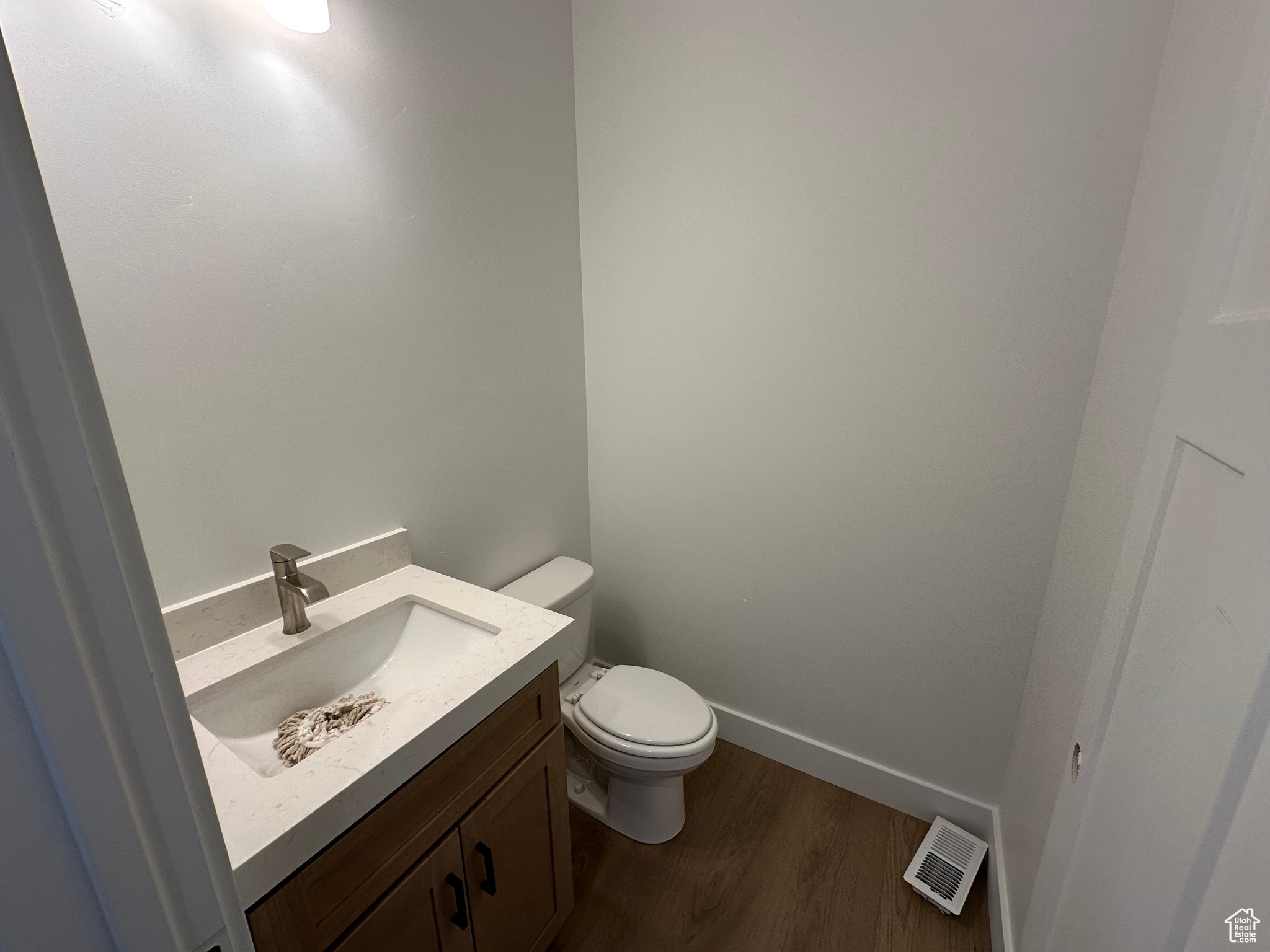 Main floor half bath in discrete location.