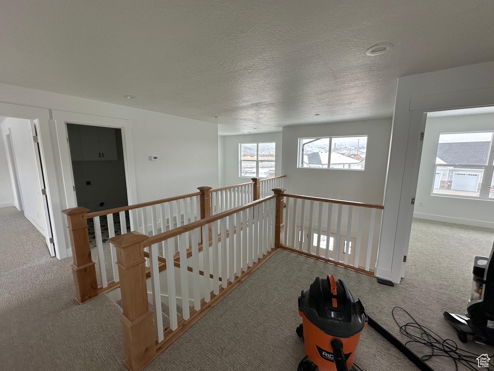 Second level landing area with access to all bedrooms, main bath, loft and laundry room.