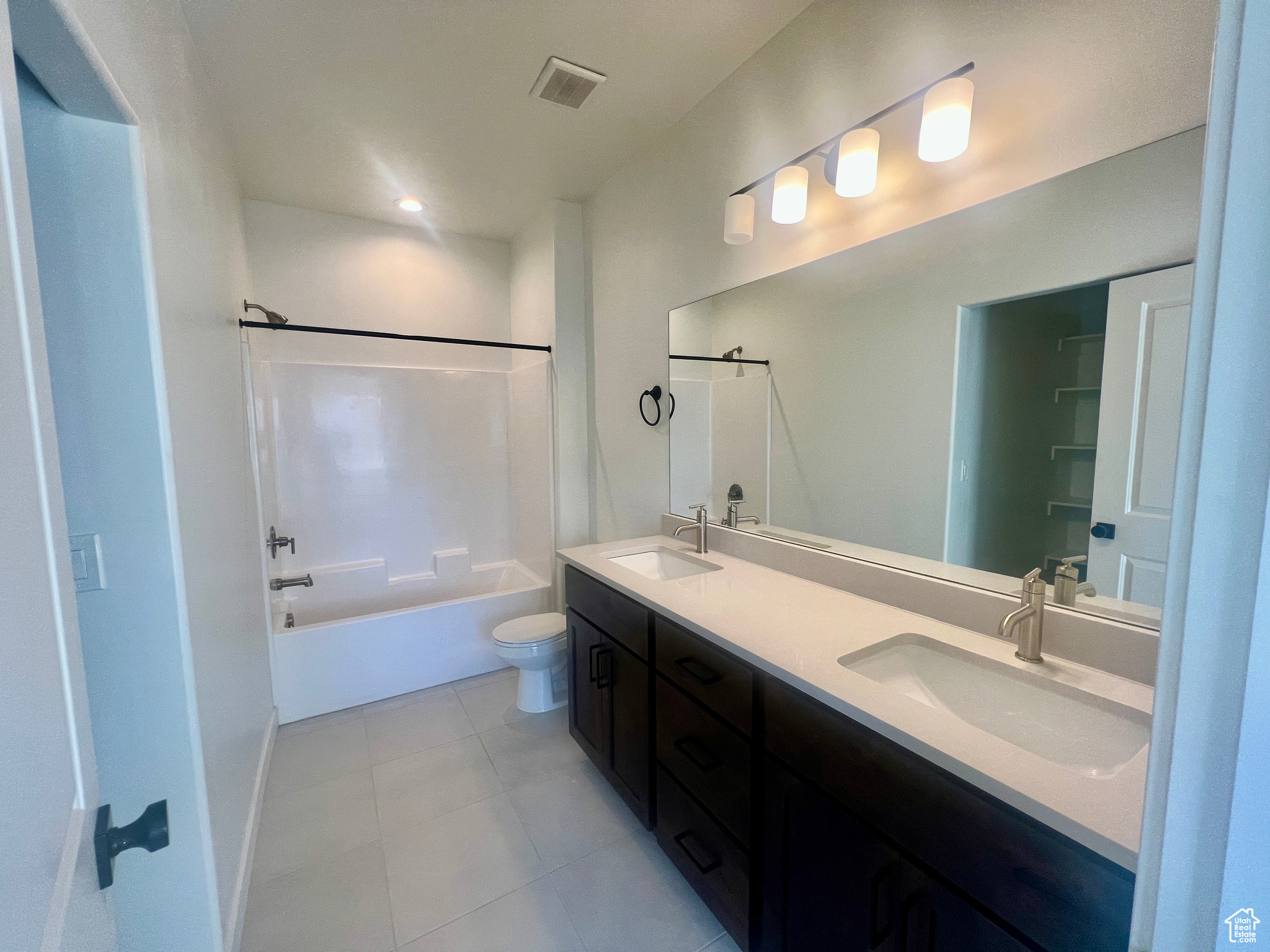 Full bathroom with shower / bathing tub combination, vanity, and toilet