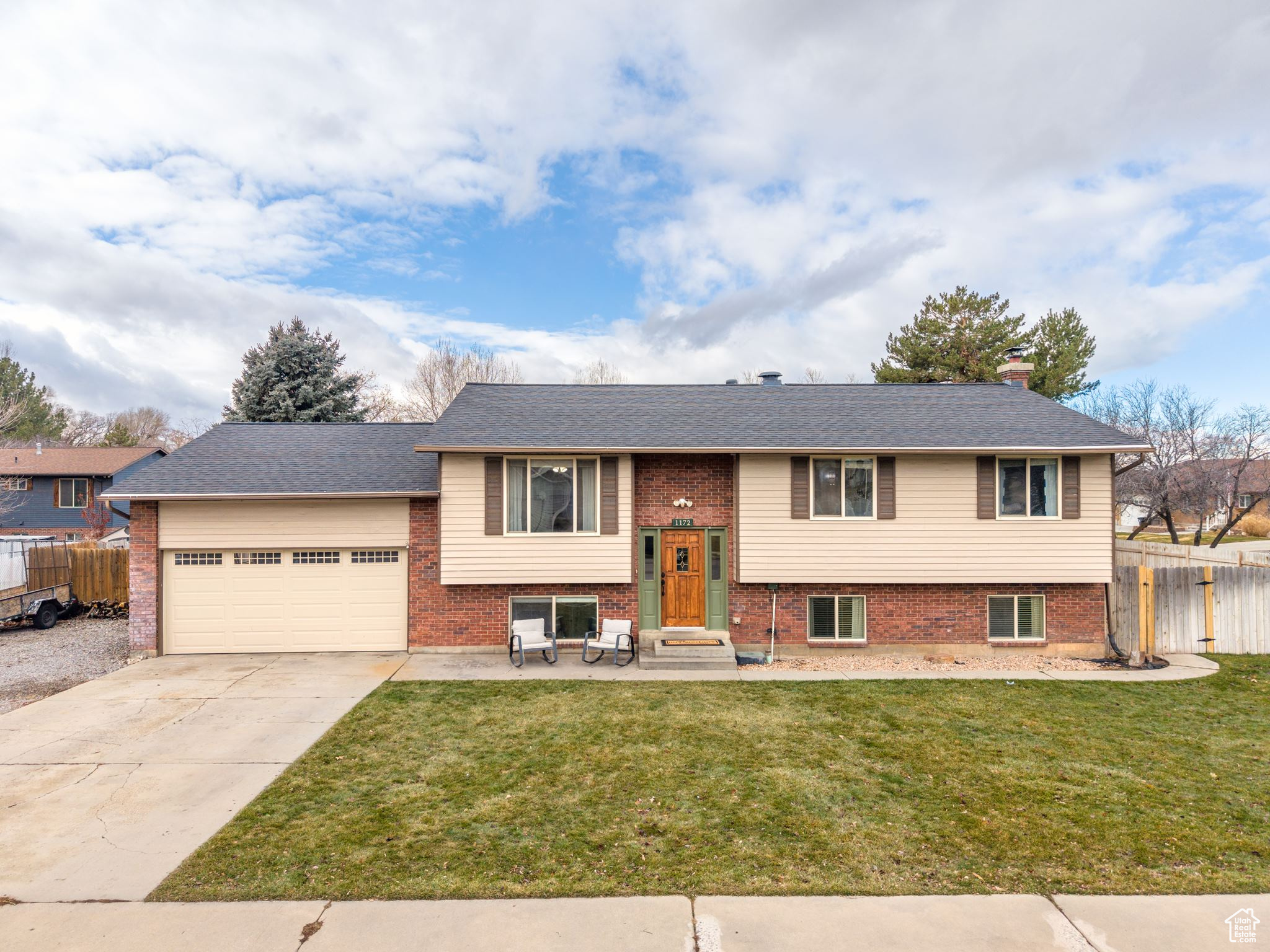 Split foyer home with a front lawn and a garage