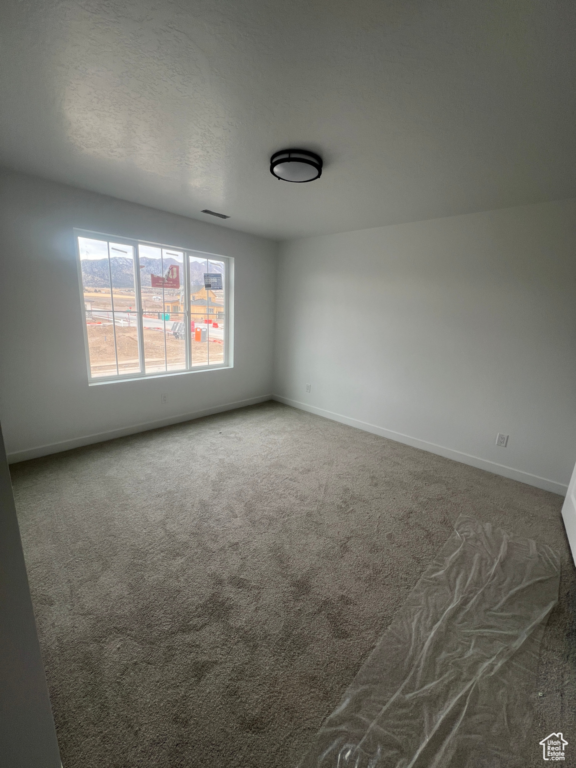 Empty room featuring carpet floors