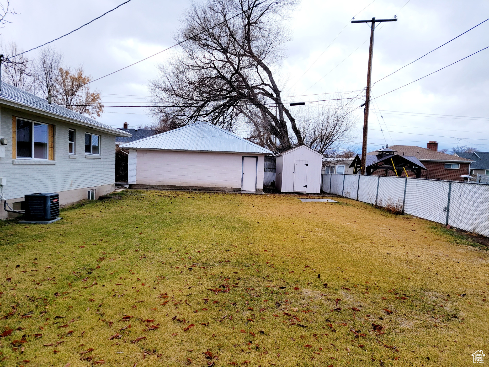 View of yard with a shed and central air condition unit