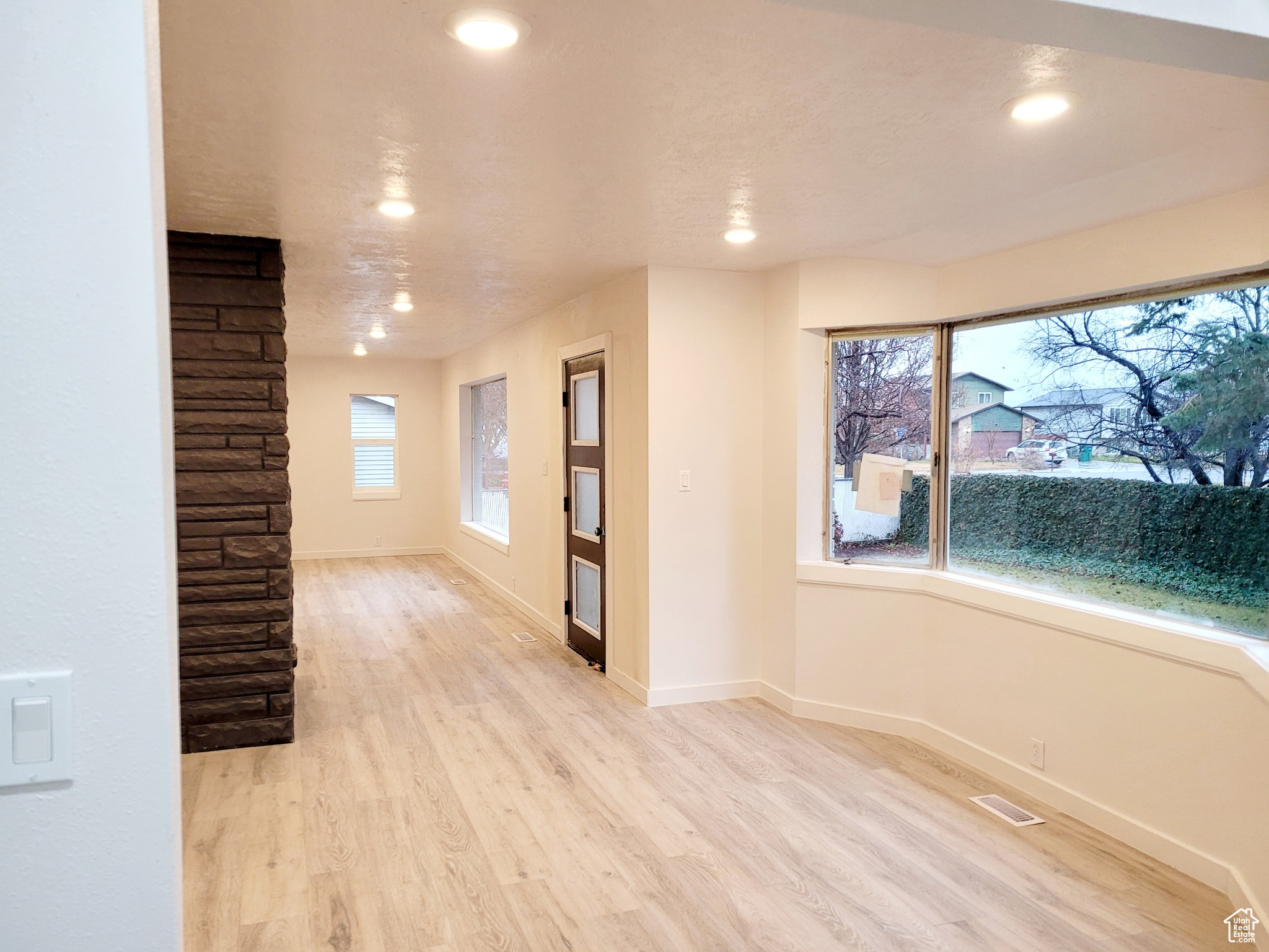 Spare room with a healthy amount of sunlight and light hardwood / wood-style flooring