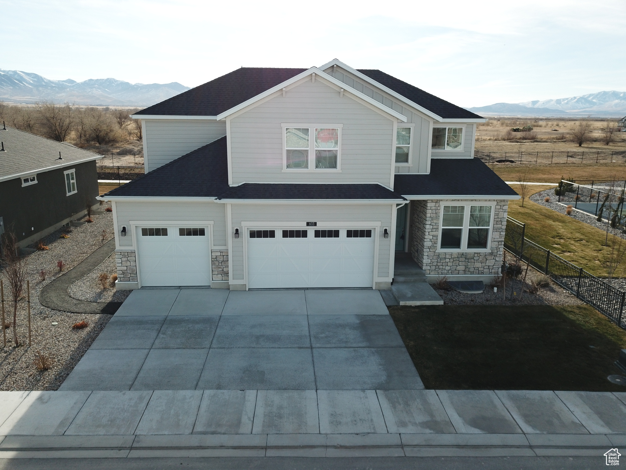 View of front of house featuring a mountain view and a garage