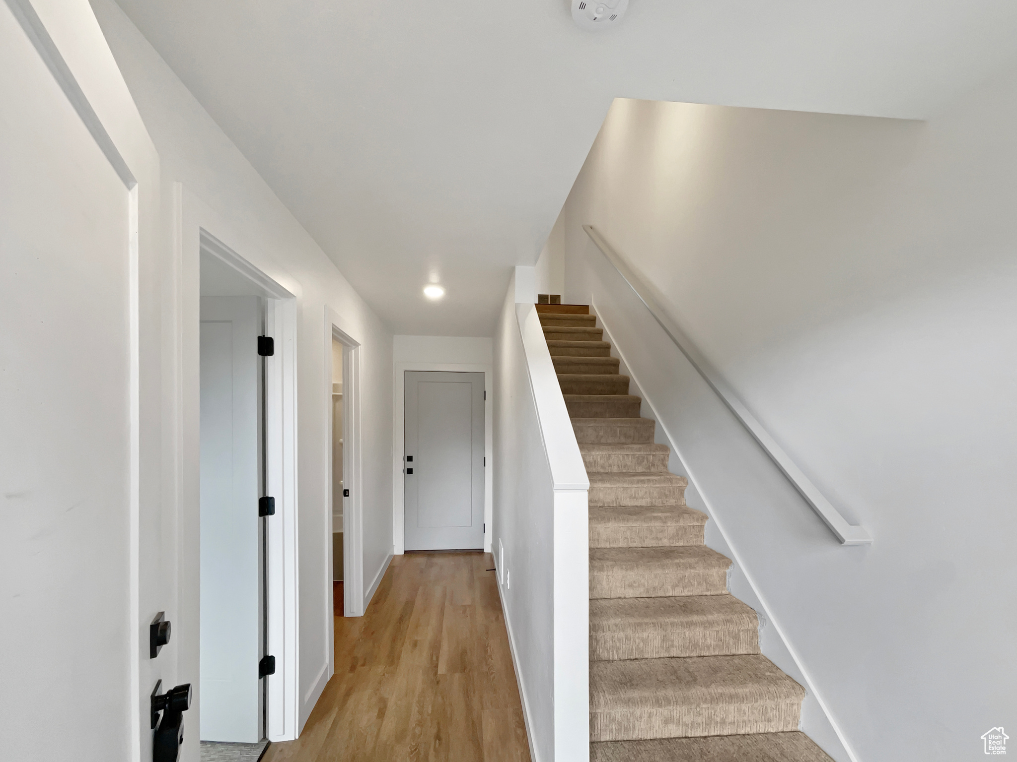 Stairs featuring hardwood / wood-style floors