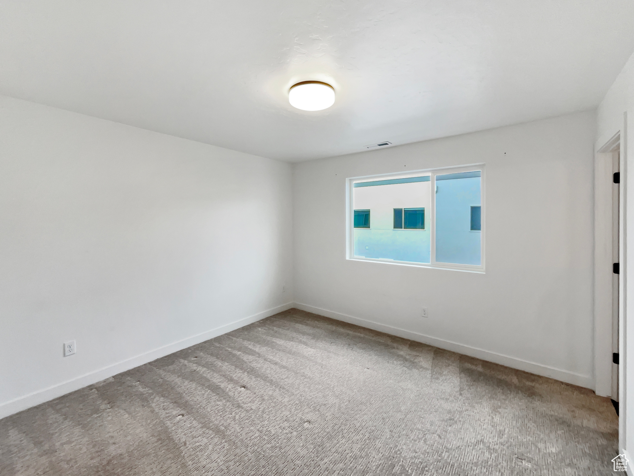 Unfurnished room featuring carpet