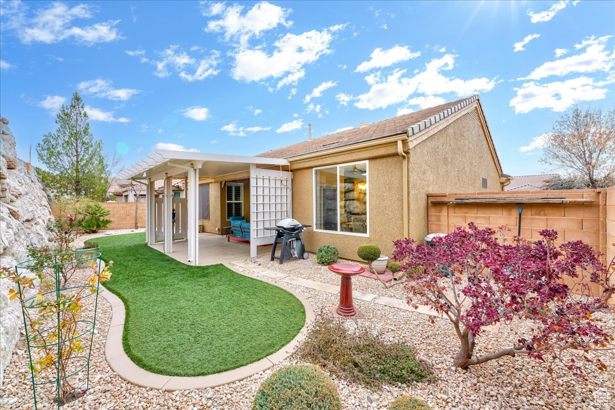 Back of property featuring a patio area and a yard